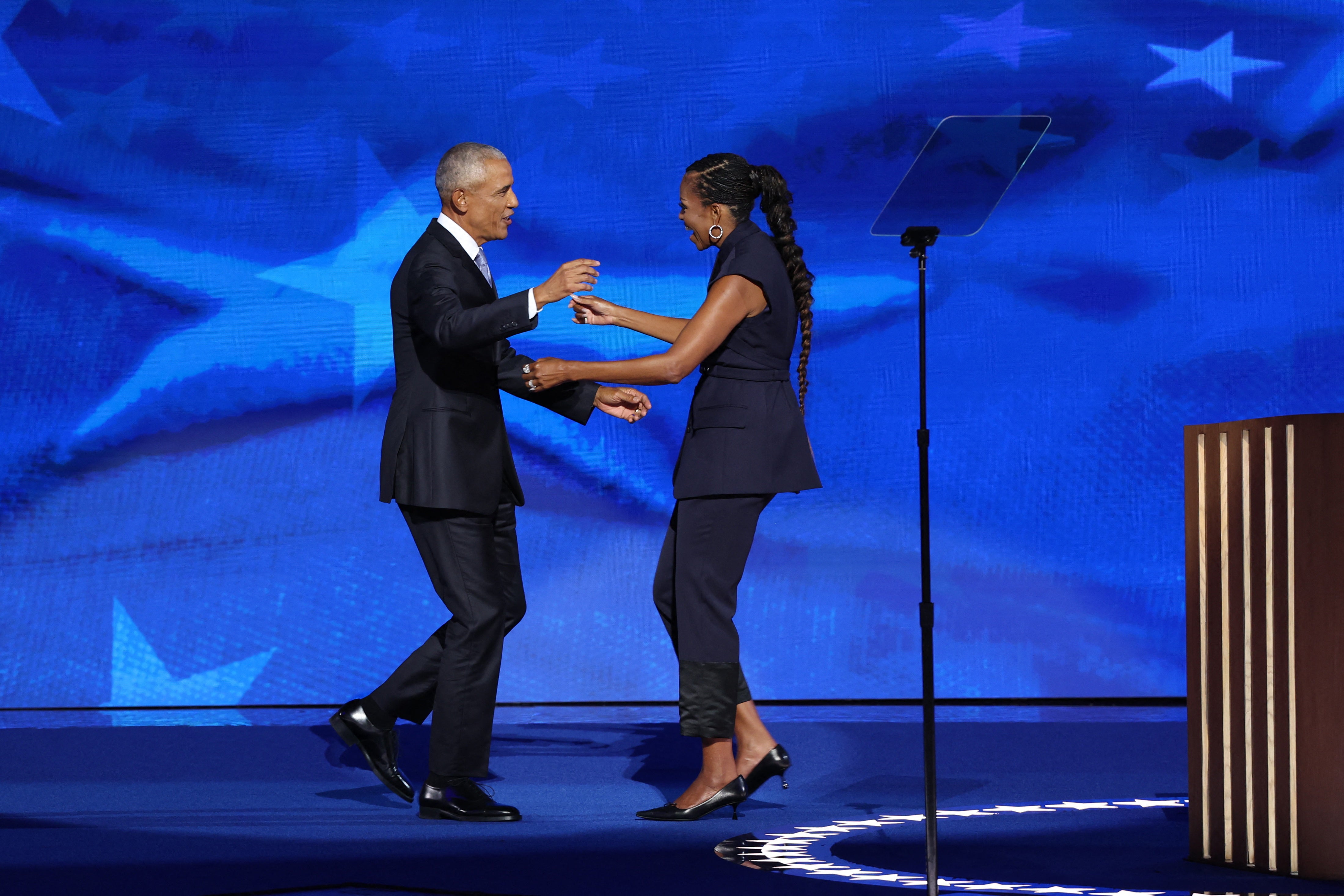 Michelle Obama welcomes her husband Barack Obama on stage before his speech on the second day of the Democratic National Convention in Chicago