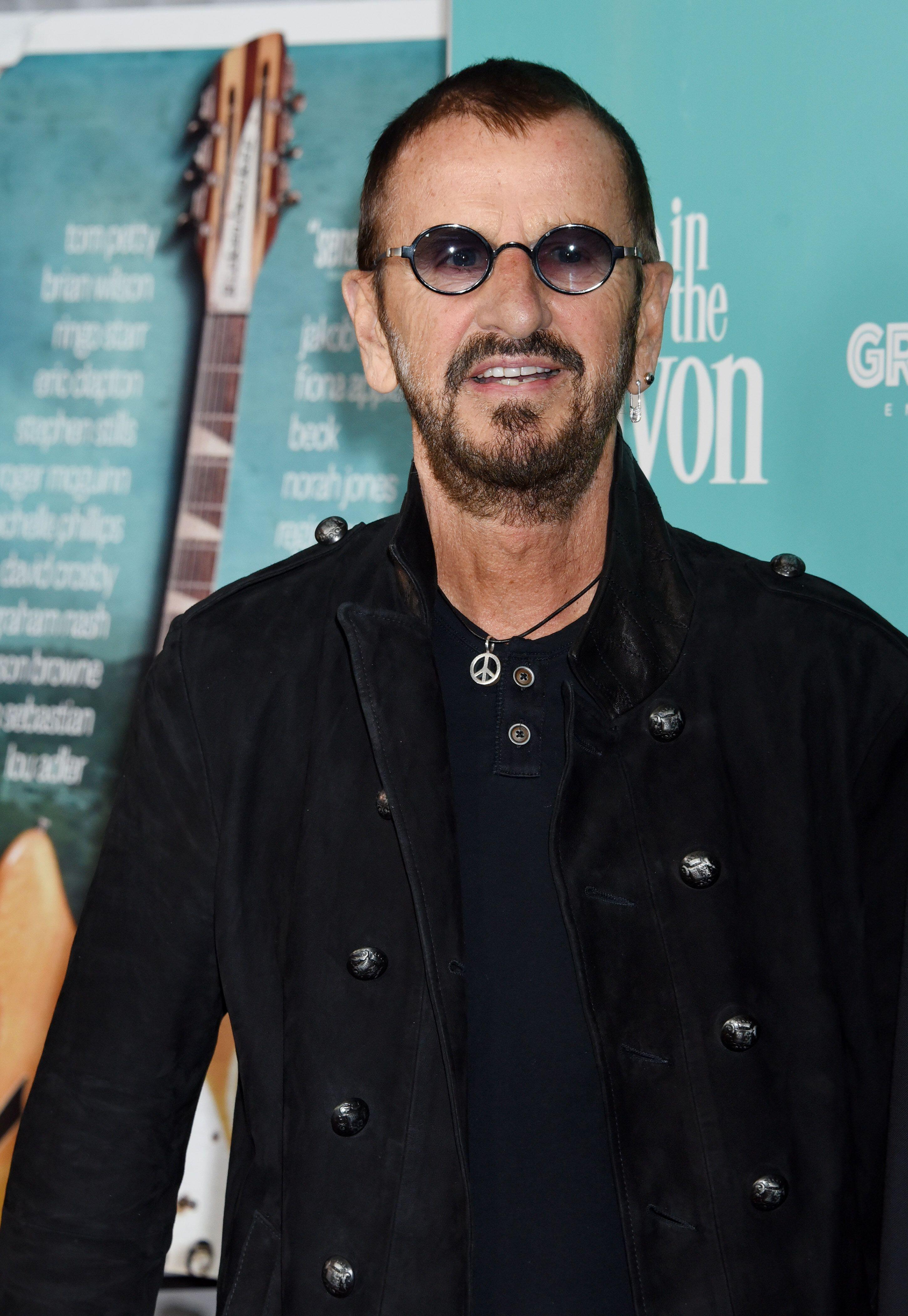 Ringo Starr later became known for his small round glasses and peace emblems (Alamy/PA)