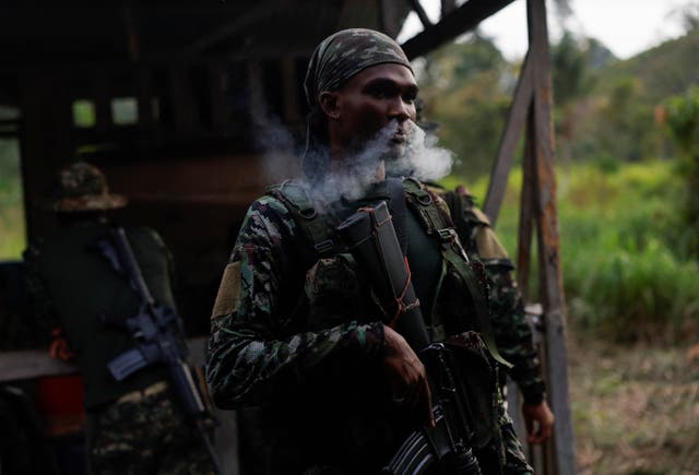 <p>A guerrilla of Colombian rebel group Segunda Marquetalia smokes a cigarette before going on patrol</p>