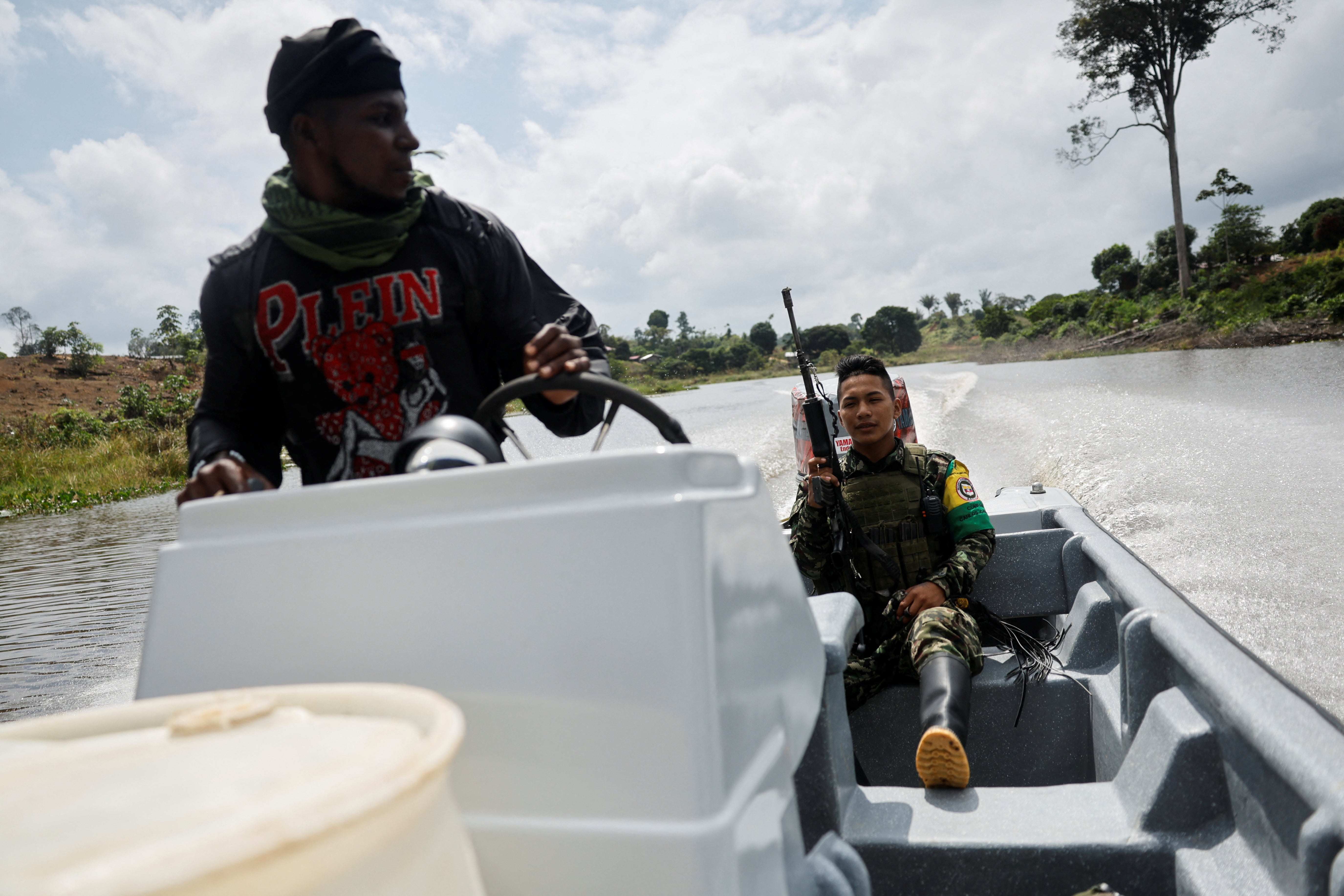 Guerrillas of Colombian rebel group Segunda Marquetalia ride in a boat, in Colombia’s Pacific jungle