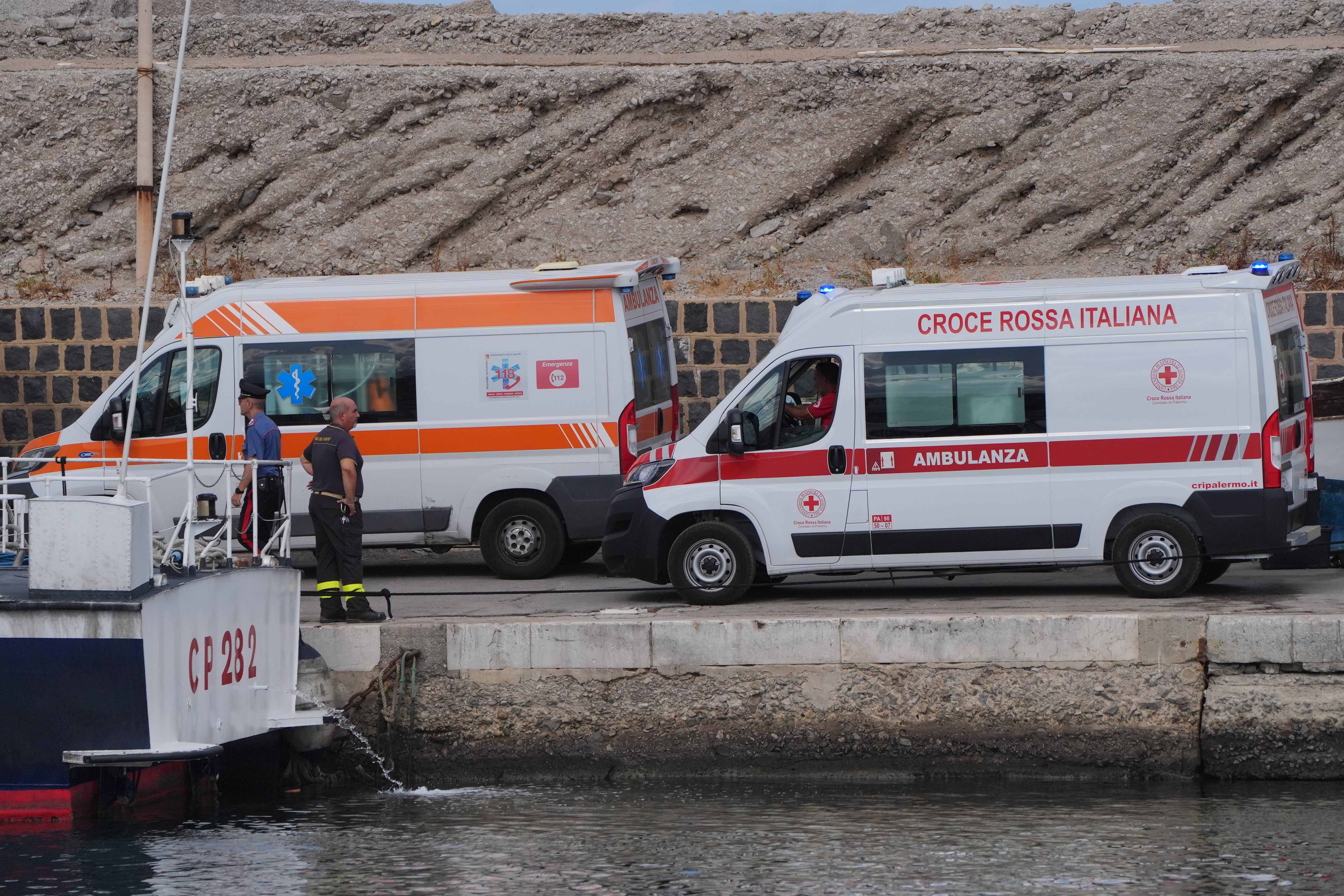 An ambulance leaving the harbour after two bodies were found