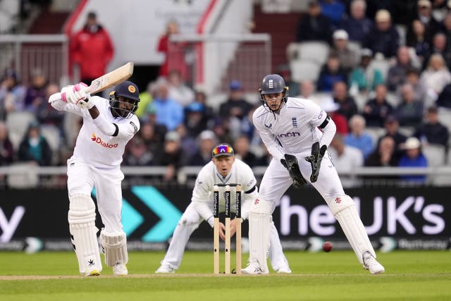 <p>Milan Rathnayake hits a shot as wicketkeeper Jamie Smith and captain Pope watch on  during day one of the First Rothesay Test match at the Emirates Old Trafford, Manchester </p>