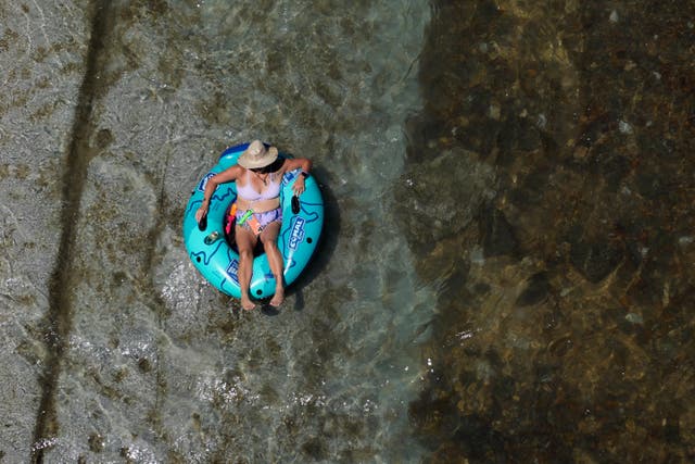 <p>A tuber floats down the Comal River on Wednesday in  New Braunfels, Texas</p>