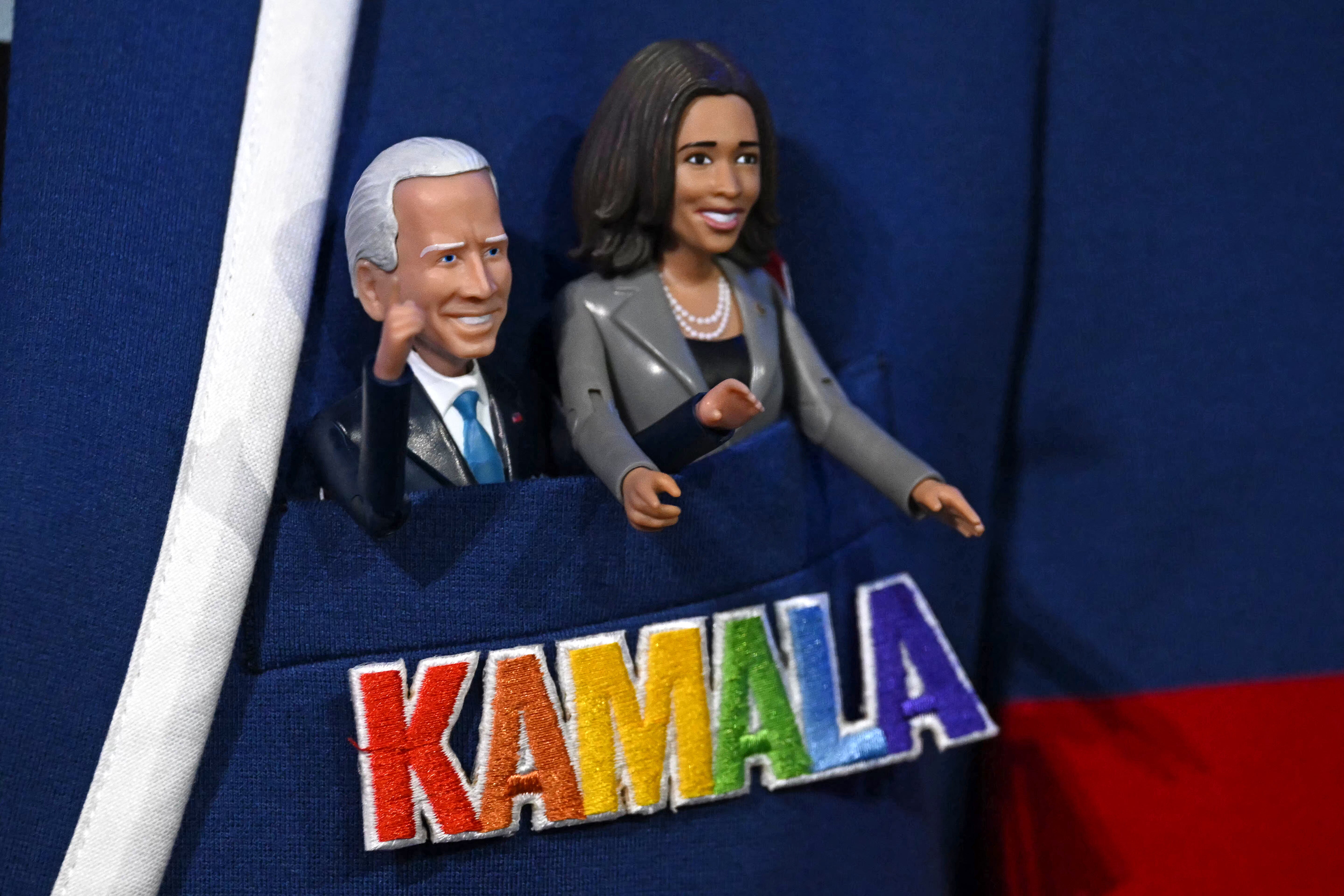 One person tucked, lowkey terrifying, figurines of President Joe Biden and Vice President Kamala Harris into their jacket pocket