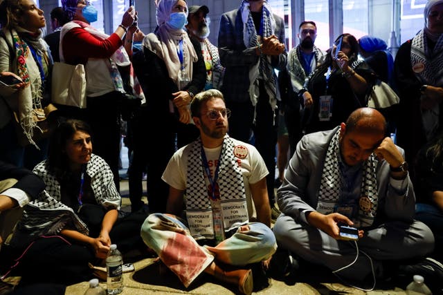 <p>A small group of uncommitted delegates hold a sit-in outside the United Center to protest the lack of a Palestinian American speaker at the Democratic National Convention on Wednesday </p>