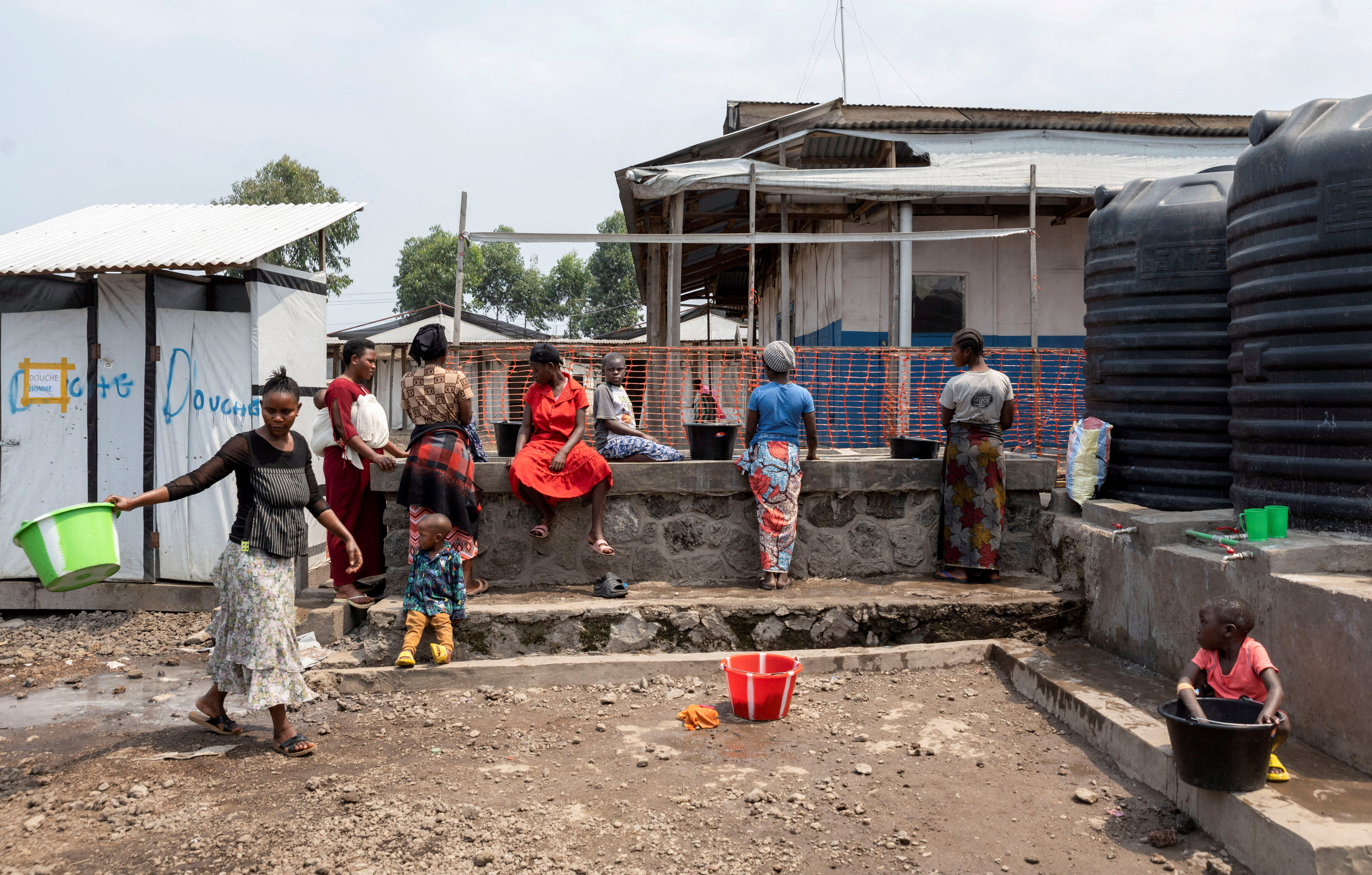 Patients gather to collect water from taps at the treatment centre for Mpox, an infectious disease caused by the Mpox virus