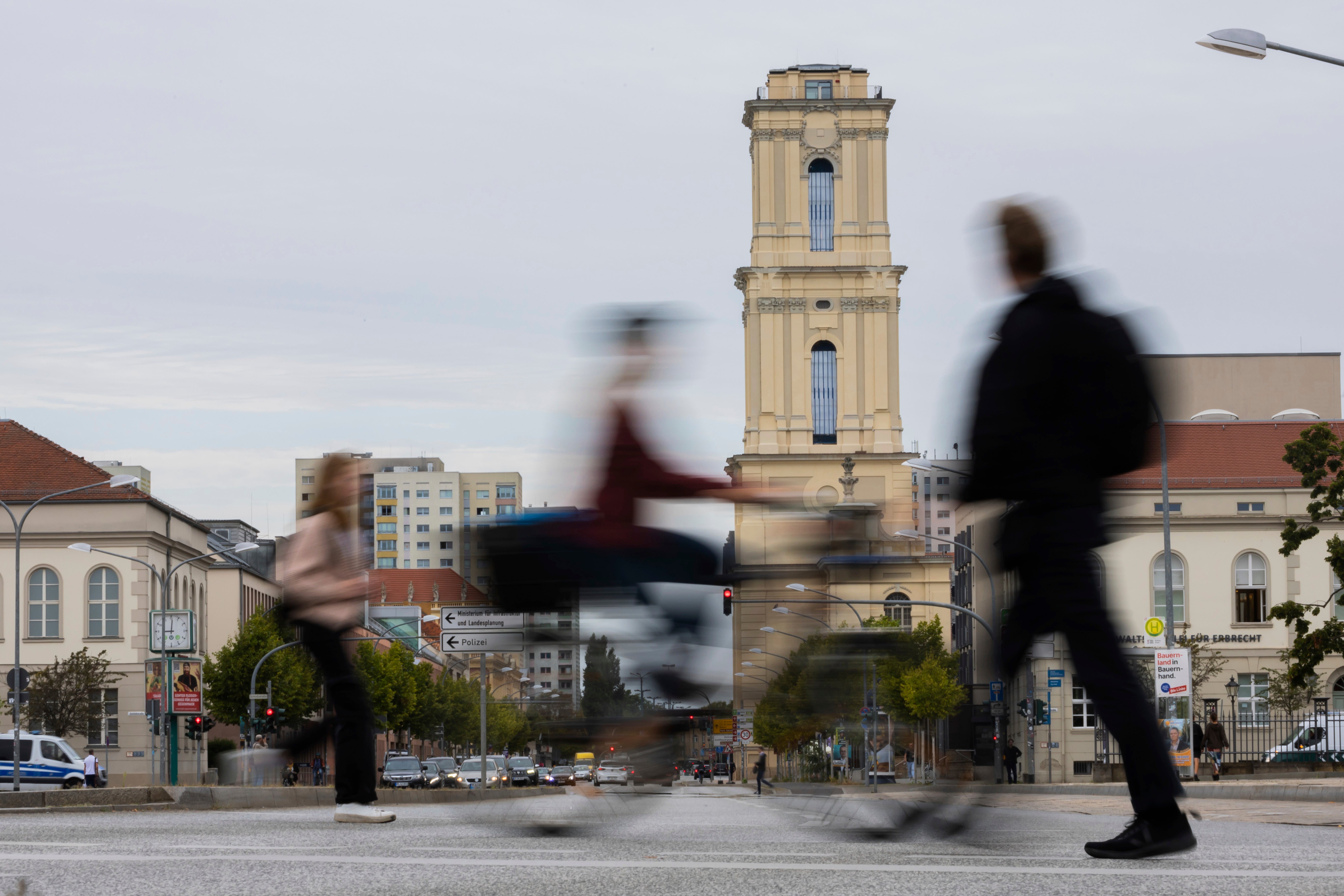 Passers-by walk in front of the tower of the Garrison Church in the city center in Potsdam, Germany