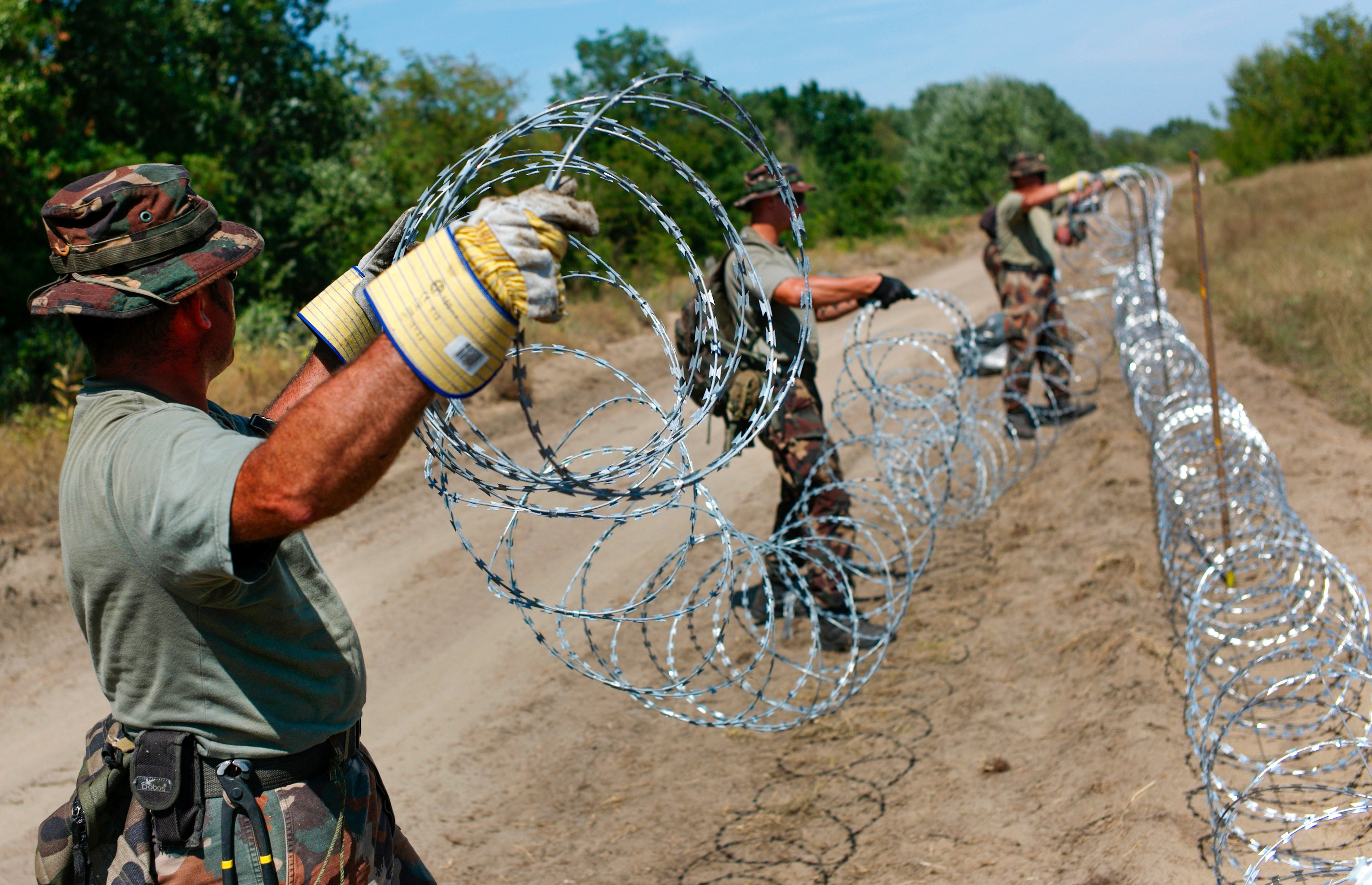 Hungarian soldiers build a fence on the Hungarian - Serbian border near Asotthalom