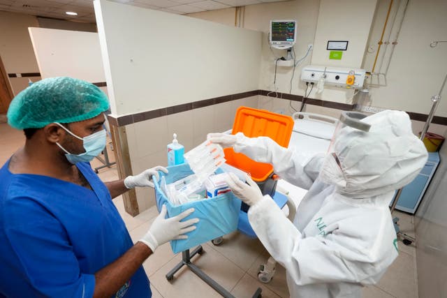 <p>Paramedic staff setting up a preventative isolation ward in  Pakistan </p>