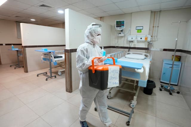 <p>A paramedical staff member prepares an isolation ward set up as a preventative measure following Pakistan's health ministry confirmation of a case of mpox in the Khyber Pakhtunkhwa province, 22 Aug 2024</p>