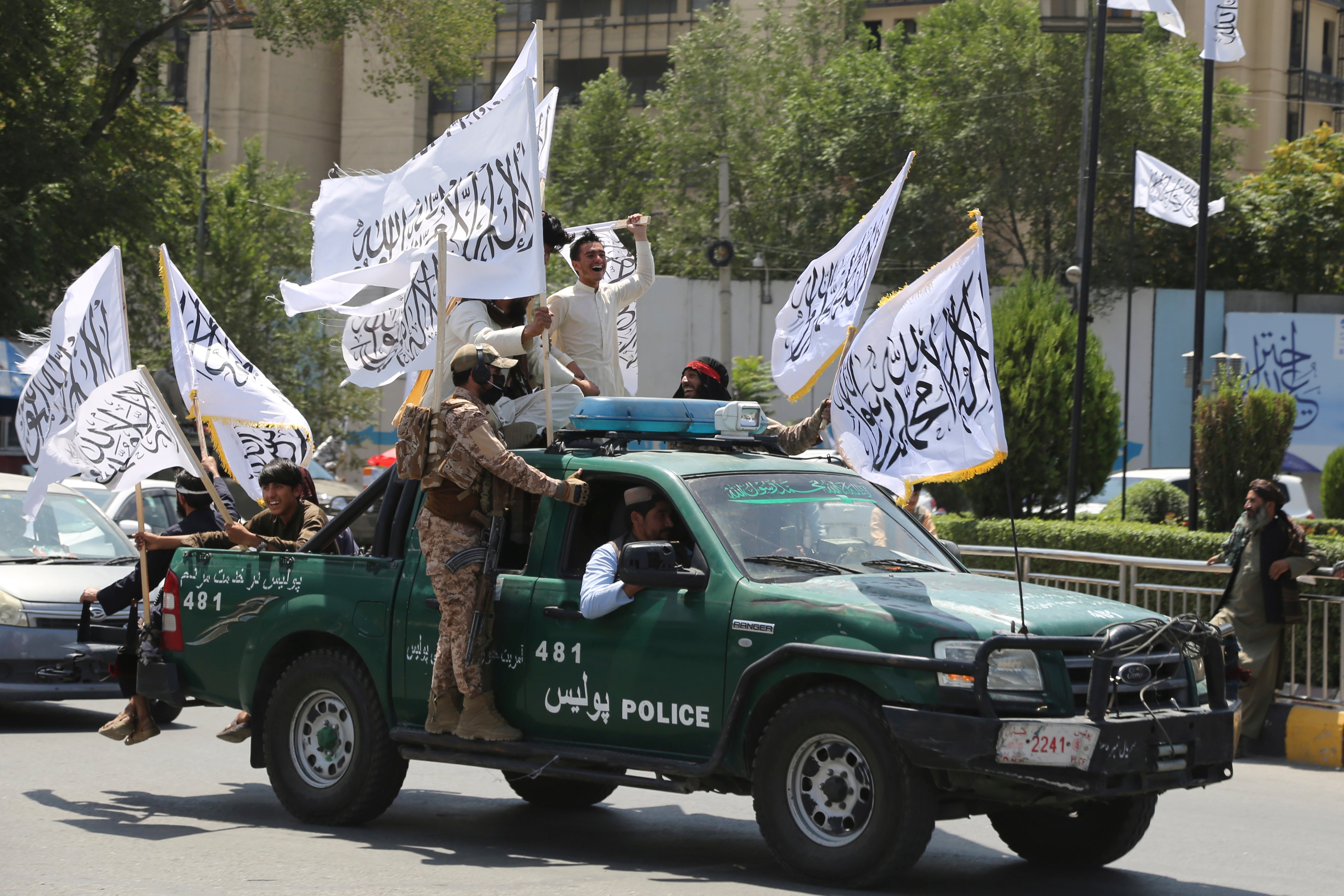 Taliban fighters celebrate the third anniversary of the withdrawal of US-led troops from Afghanistan, in Kabul