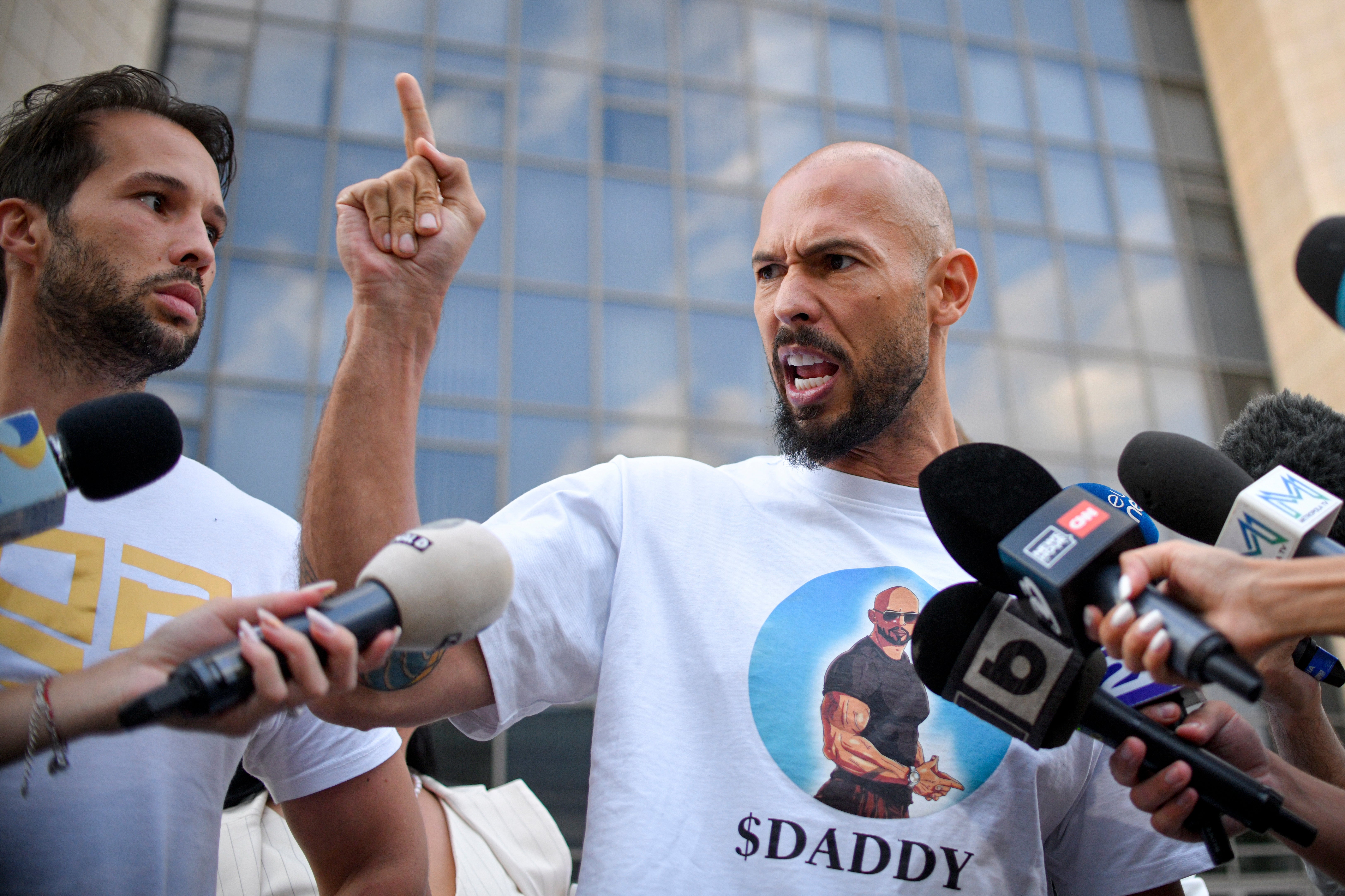 Andrew Tate and his brother Tristan, left, speaking to the media in Bucharest, where he faces separate criminal charges