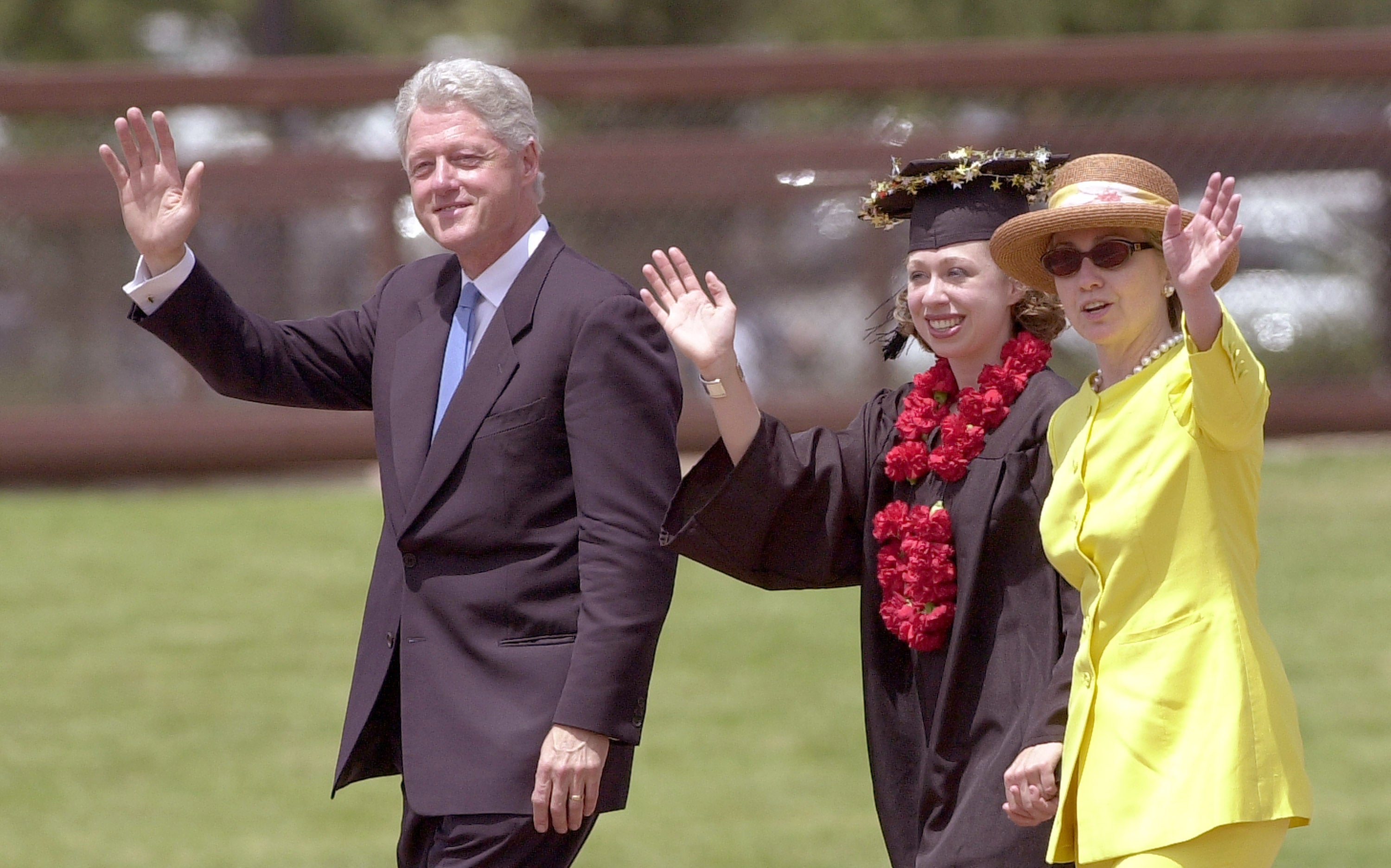 Bill, Chelsea and Hillary Clinton leave Stanford University's graduation ceremony in 2001.