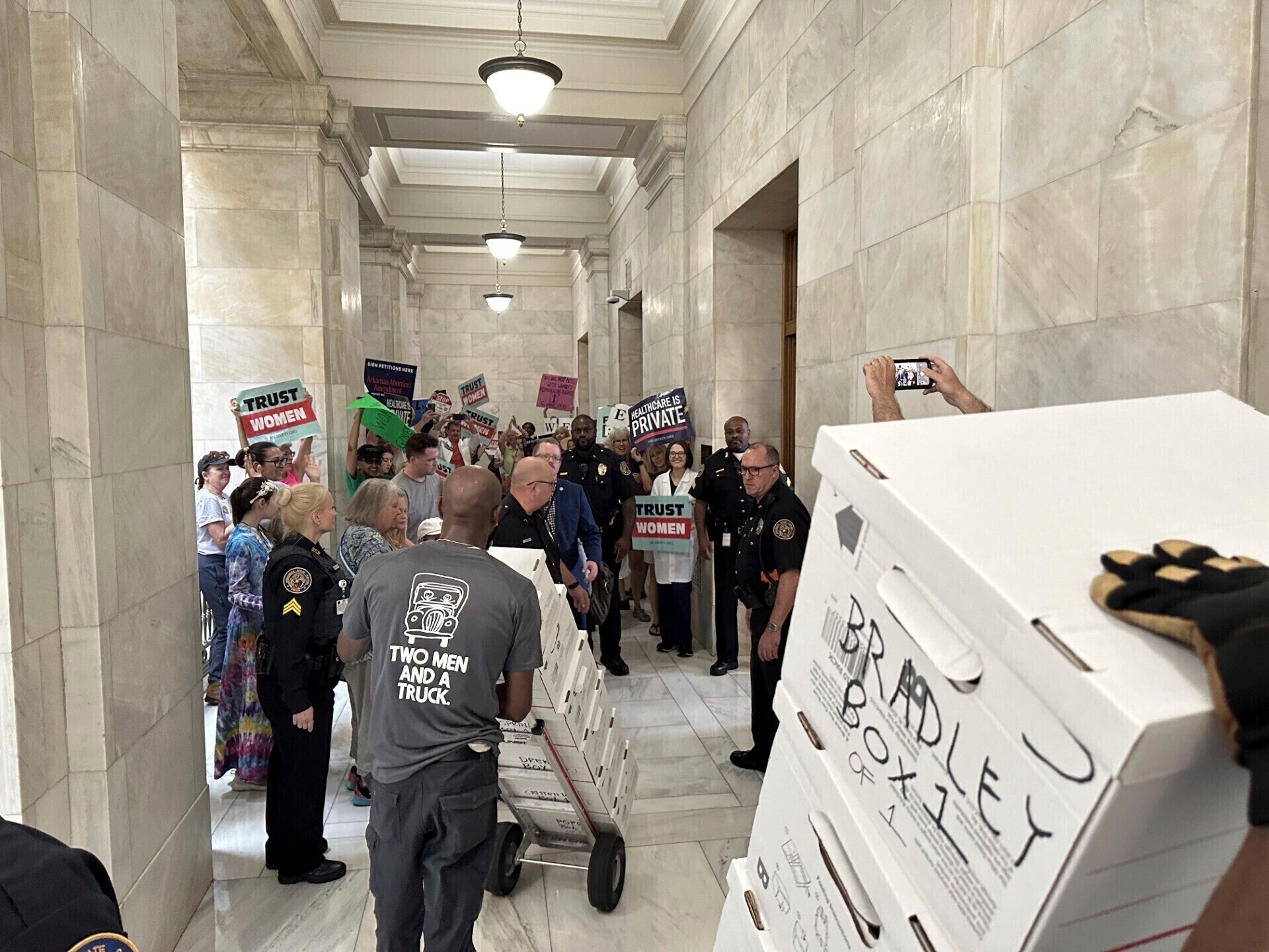 On July 5, boxes of signatures in support of a proposed ballot measure to repeal Arkansas's abortion ban are delivered to a room in the state Capitol.