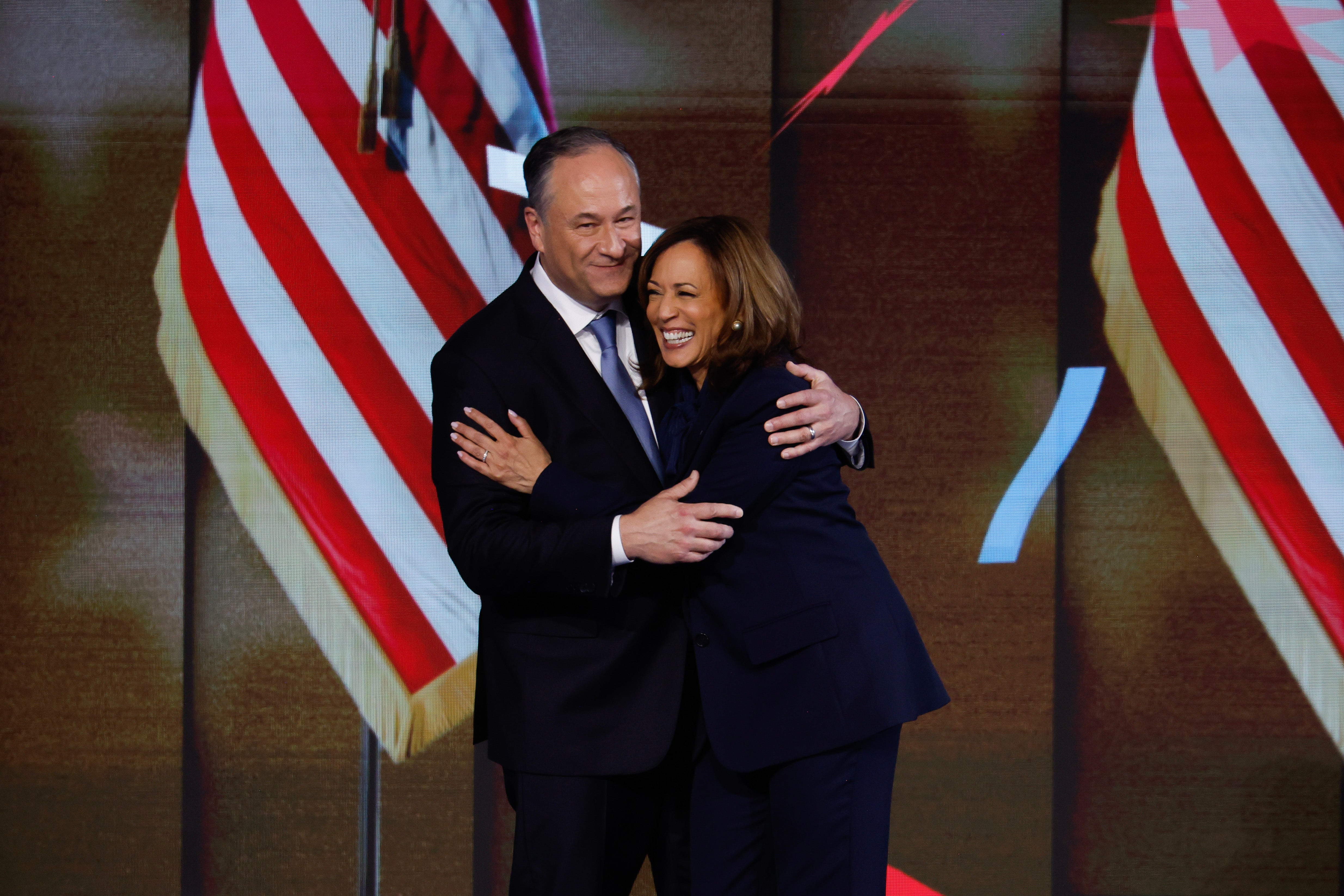 Doug Emhoff hugs Kamala Harris after she accepted the Democratic nomination for president on August 22. Today is also their wedding anniversary