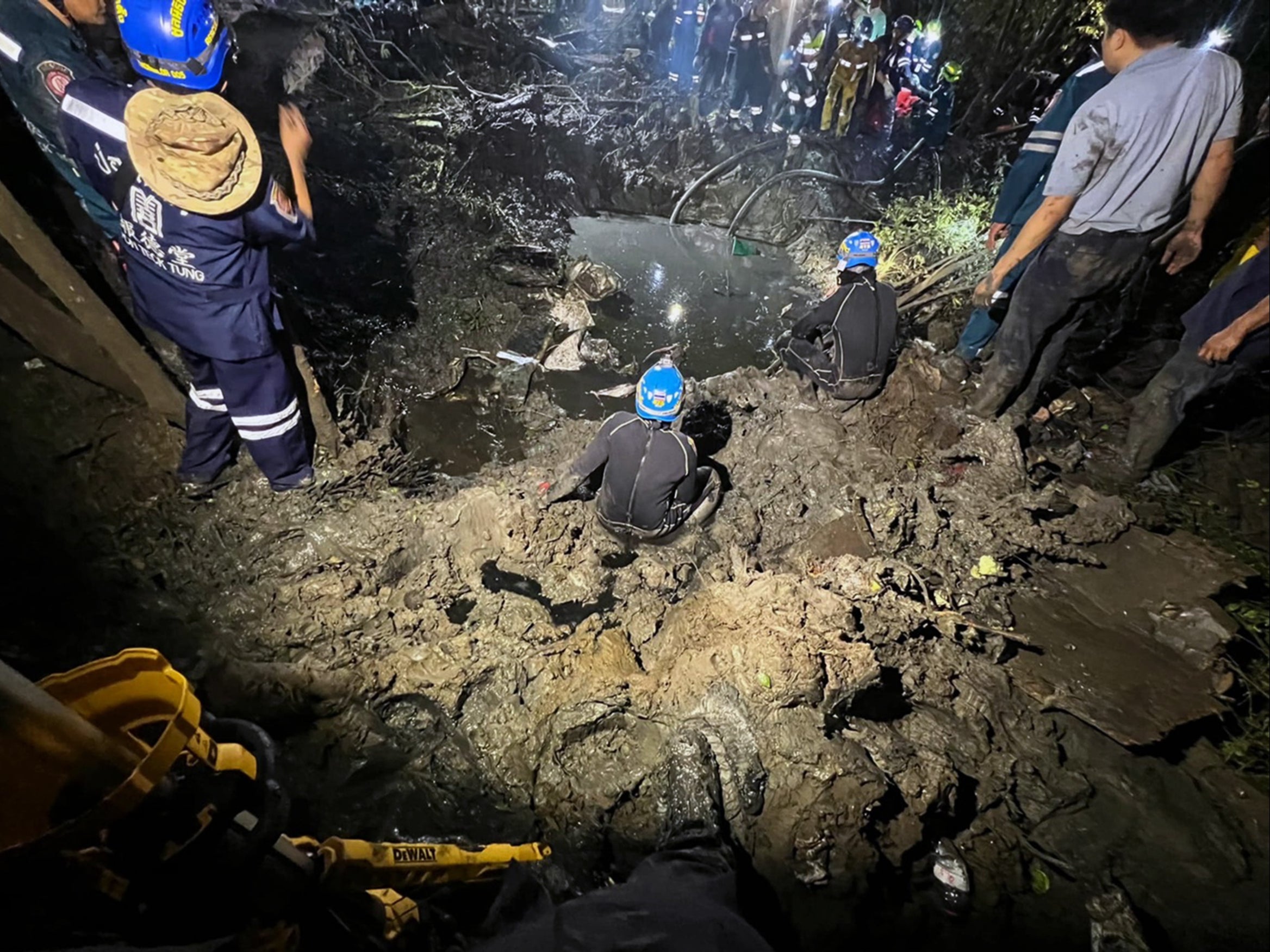 A handout photo made available by the Poh Teck Tung Foundation shows rescue workers conducting a search and rescue operation to recover the wreckage of a plane after it crashed into a mangrove forest in Chachoengsao province, Thailand. All nine passengers, including five Chinese tourists from Hong Kong, two Thai female crew and the Thai pilot and co-pilot were killed in the crash, according to the governor of Chachoengsao province