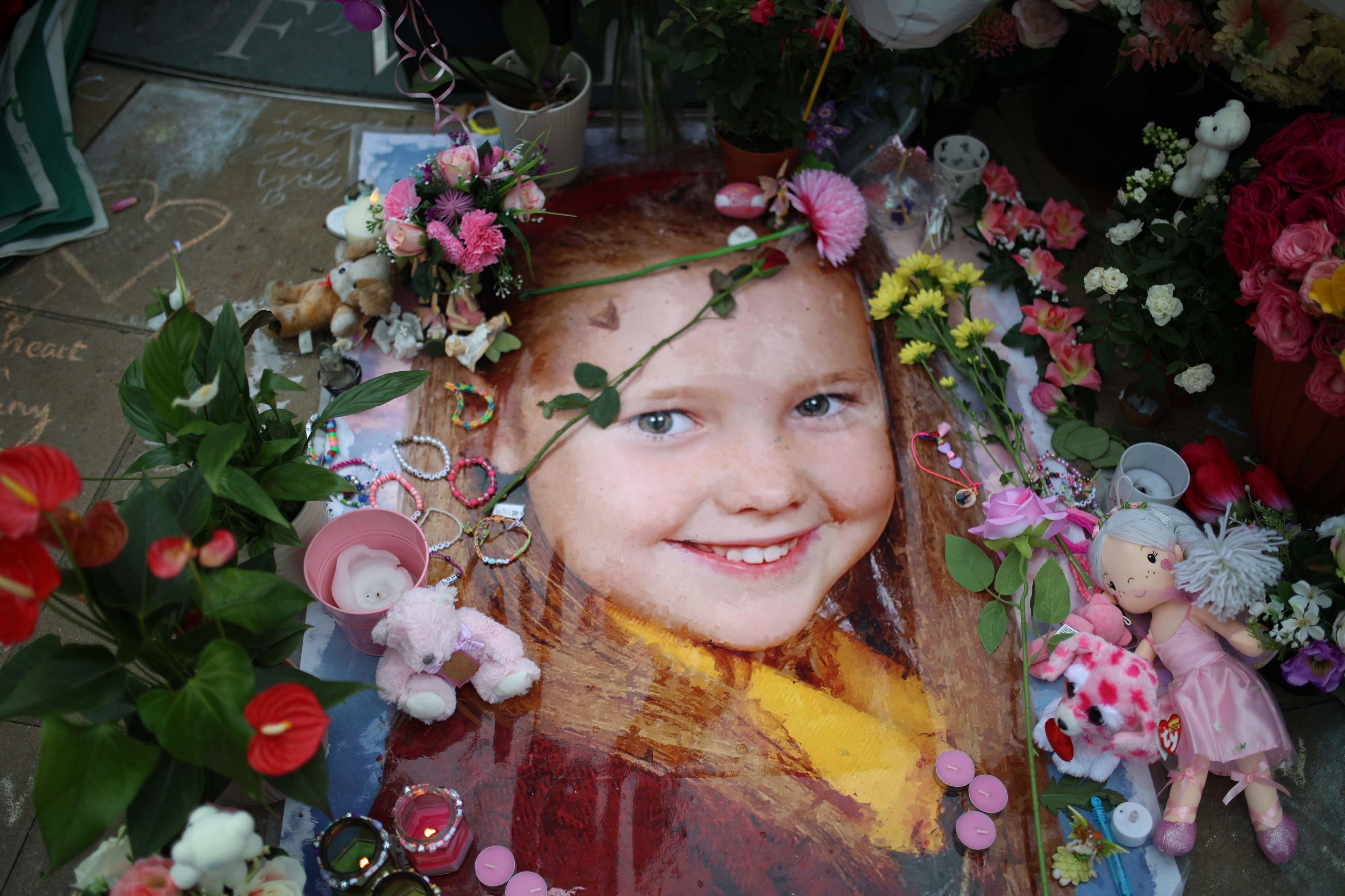 A floral tribute placed in a picture of Elsie Dot Stancombe outside the Town Hall in Southport (Ryan Jenkinson/PA)