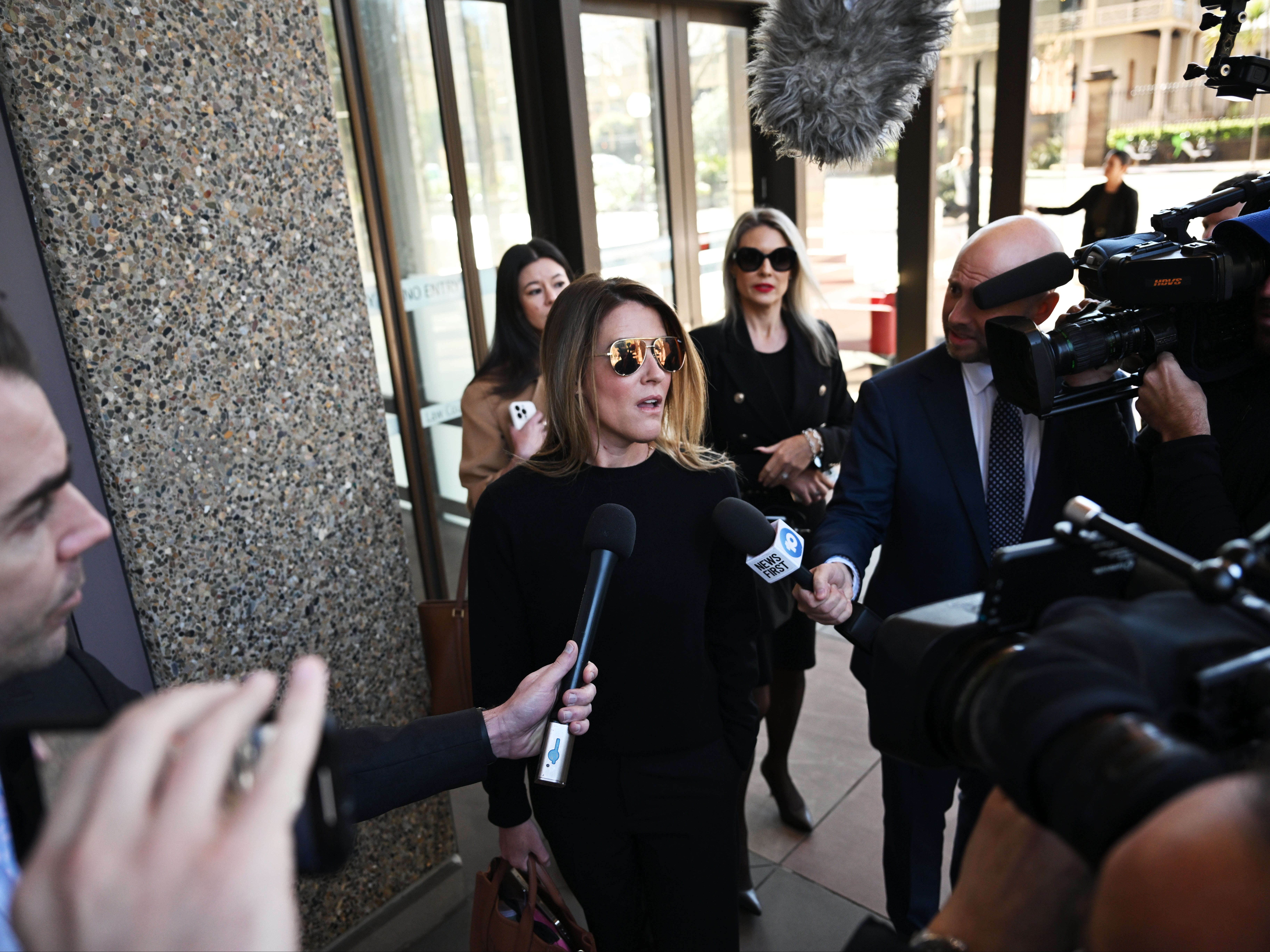 Giggle for Girls founder Sall Grover (C) speaks to the media as she leaves the Federal Court of Australia in Sydney, Australia, 23 August 2024