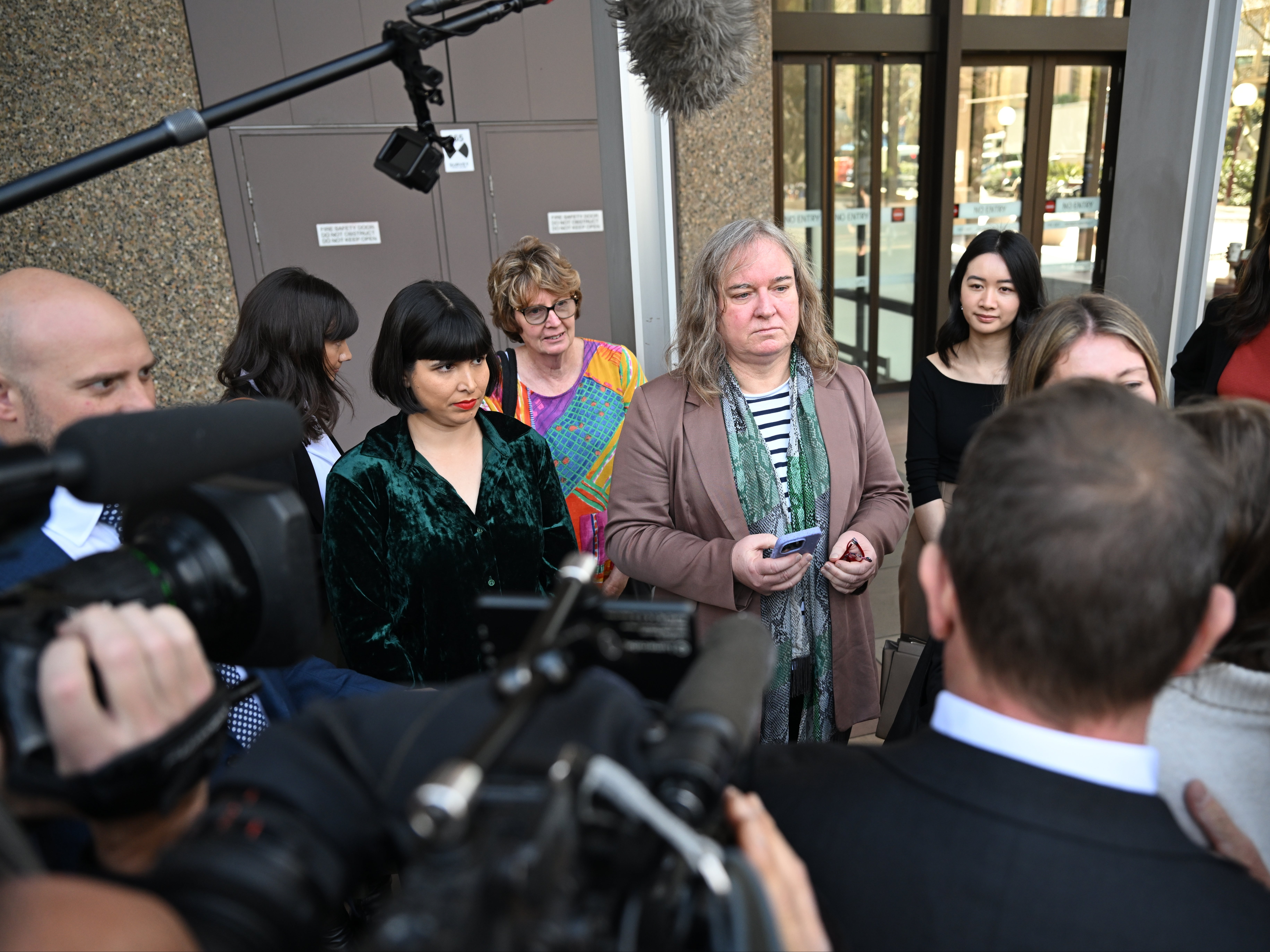 Roxanne Tickle (C) speaks to the media as she leaves the Federal Court of Australia in Sydney, Australia, 23 August 2024