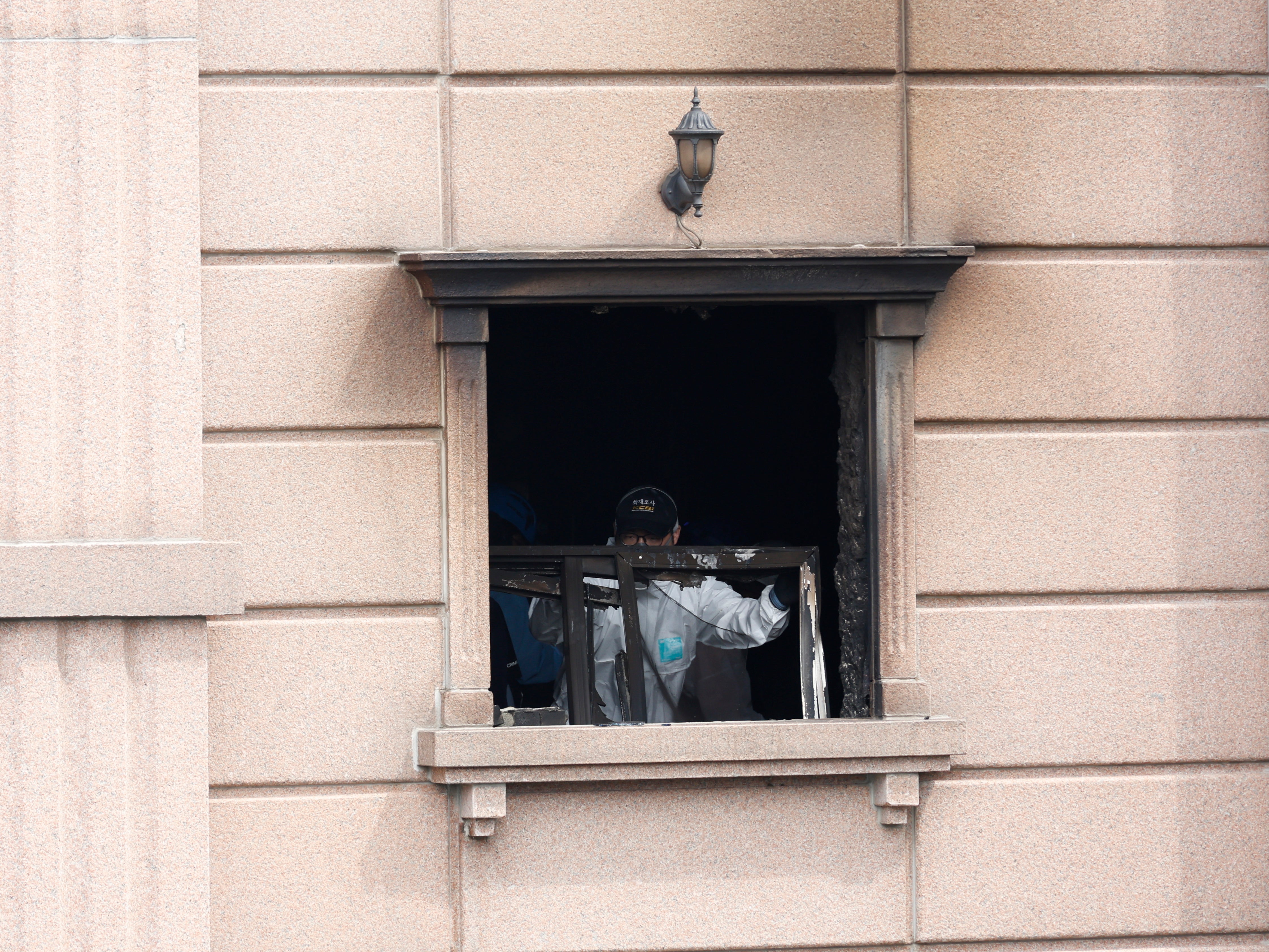 A joint investigation team examines the scene of a fire at a hotel in Bucheon, about 25 km west of Seoul, South Korea, August 23, 2024