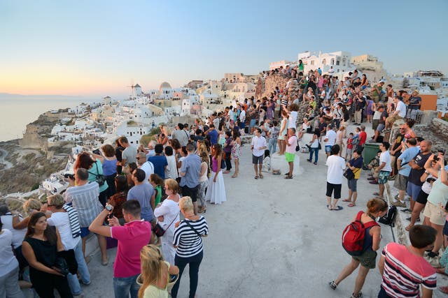 <p>Santorini’s famed sunsets are known for drawing a crowd </p>