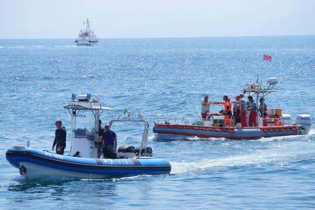 An Italian fire service dive team return to port on the fifth day of the search (Jonathan Brady/PA)