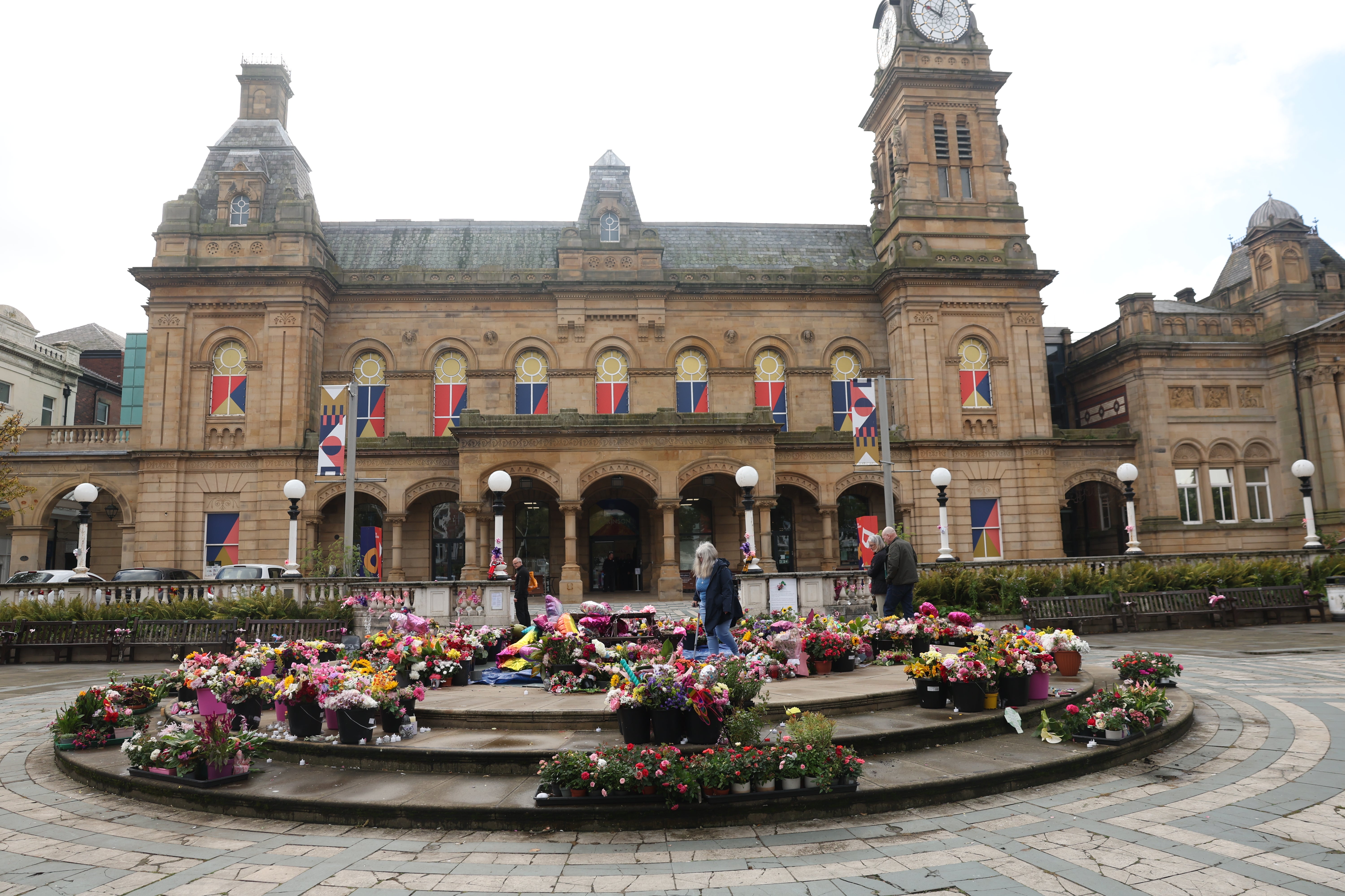 The procession went through a flower tribute outside Atkinson arts centre following the service