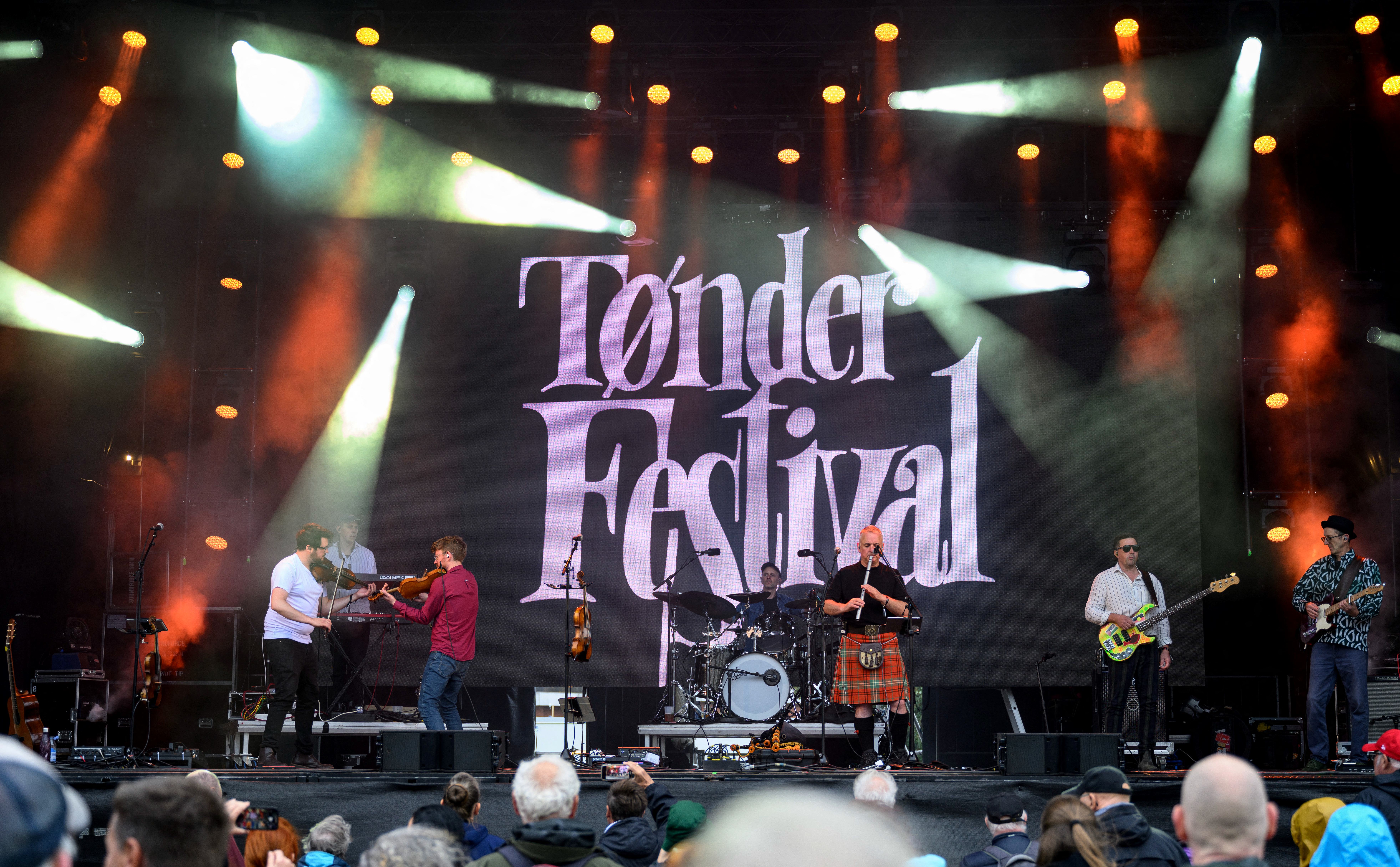 Scottish band Peatbog Faeries performs on the open air stage at the Toender Festival of folk music as Storm Lilian approaches Jutland, Denmark