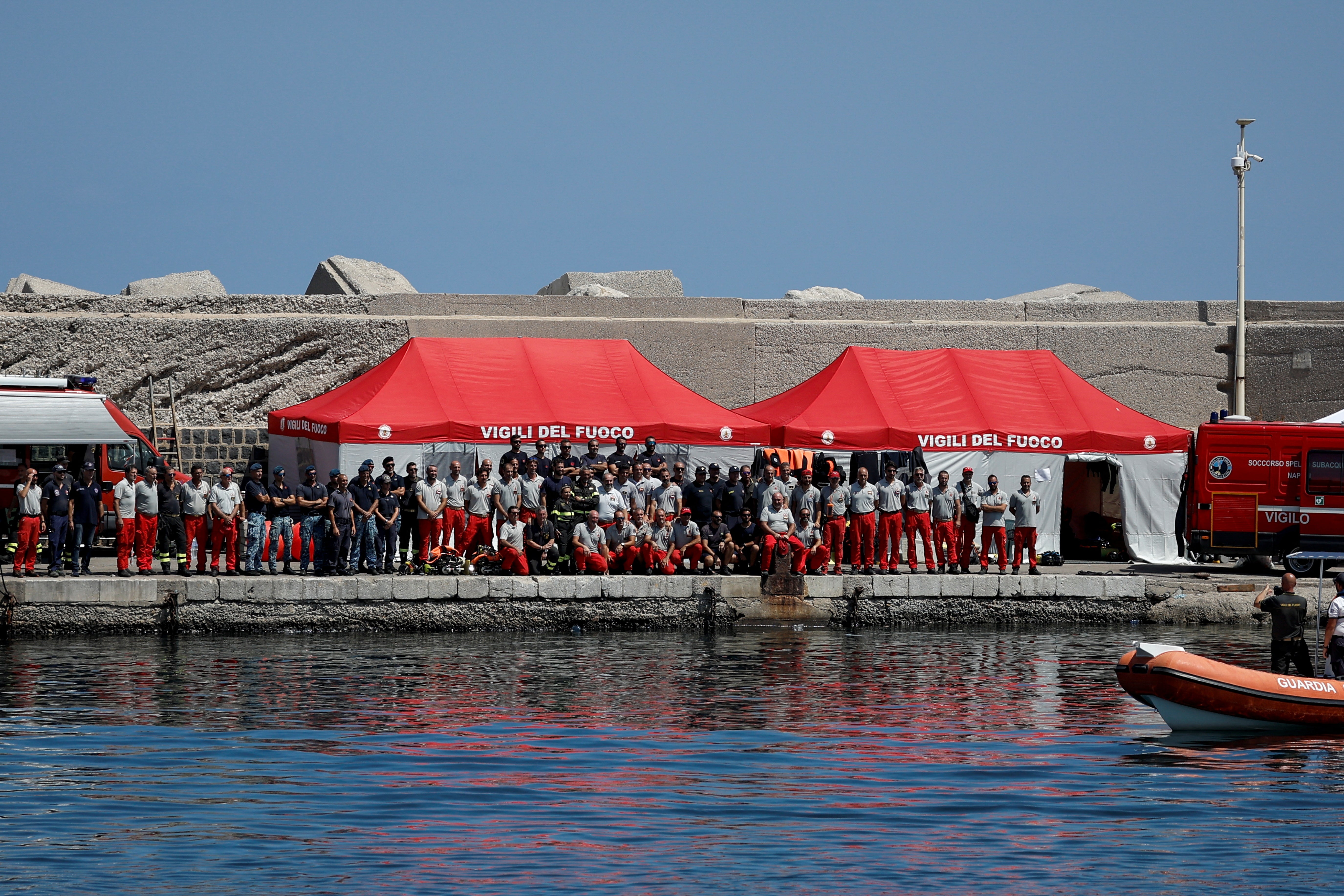 Rescue workers line the harbour after Hannah Lynch’s body is recovered