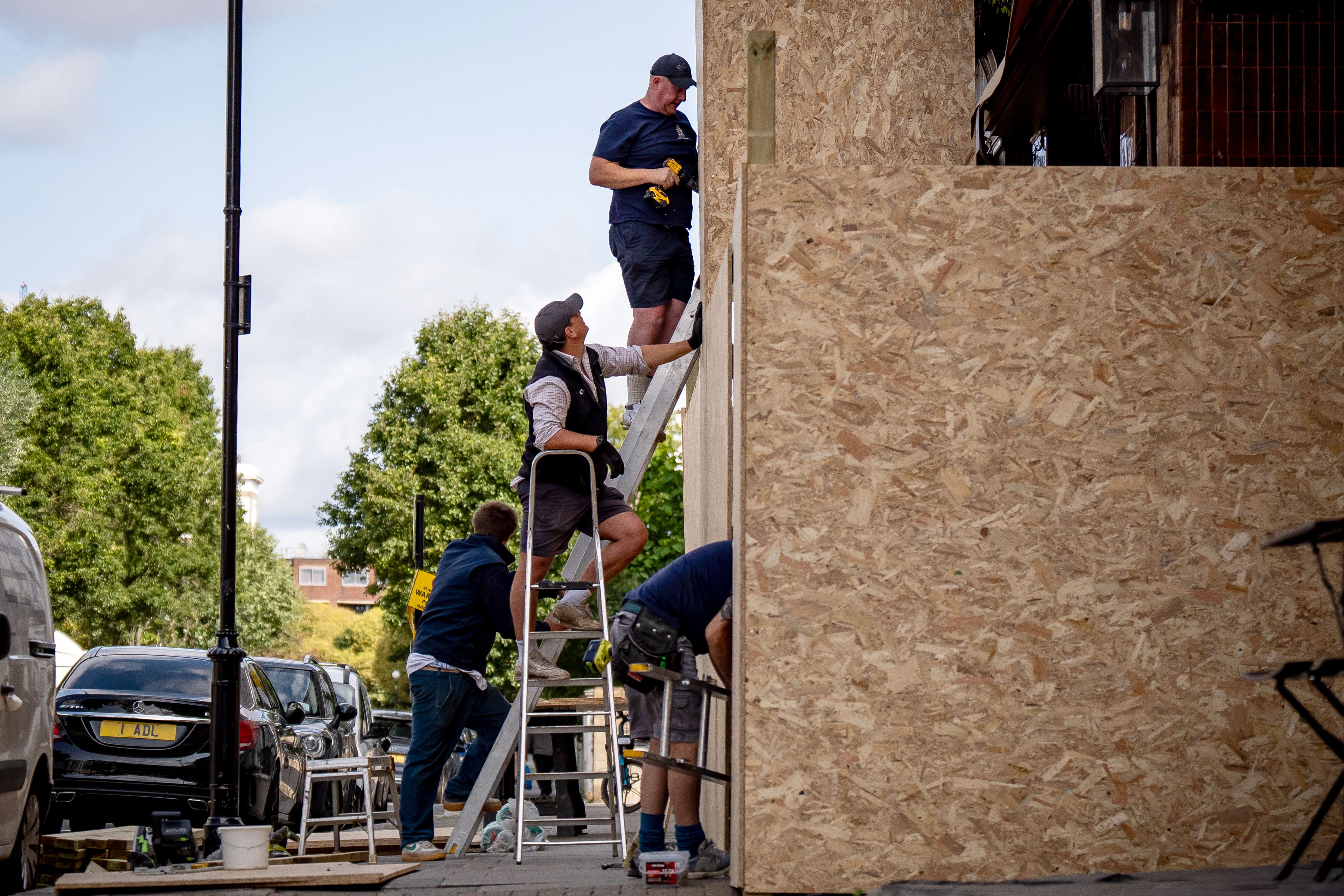 Workmen attach boards to the Walmer Castle pub as preparations continue ahead of this year’s Notting Hill Carnival (Aaron Chown/PA)