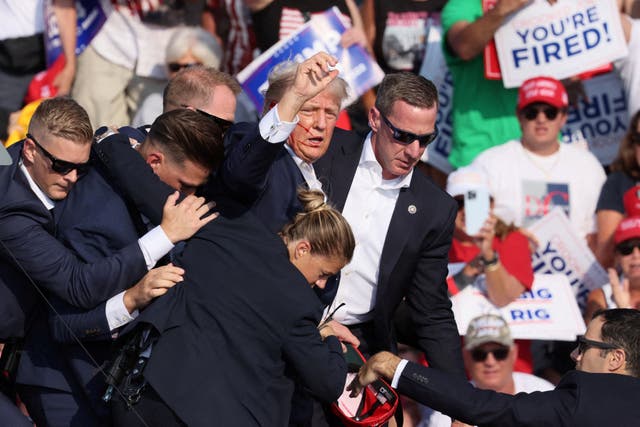<p>Members of Donald Trump’s Secret Service detail surround him after shots were fired at his rally in Butler, Pennsylvania on July 13 </p>