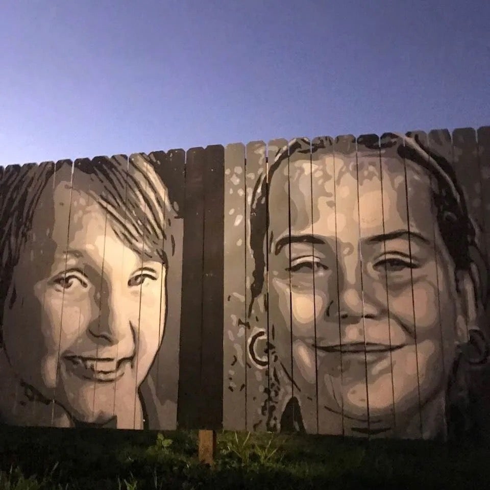 A mural of the cousins ​​etched into a fence