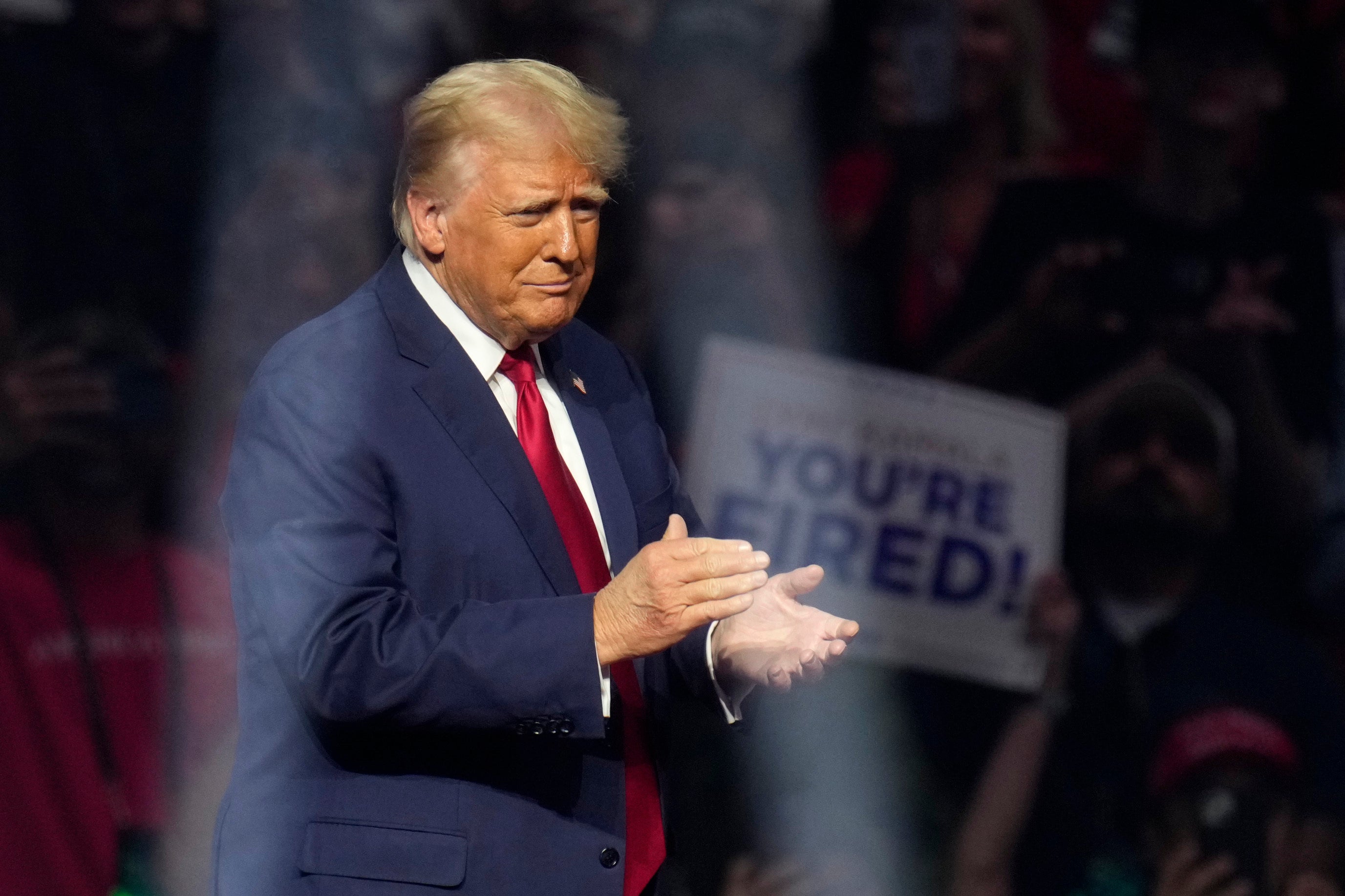 Republican presidential nominee former President Donald Trump walks on stage to speak at a campaign rally Friday, Aug. 23, 2024, in Glendale, Arizona