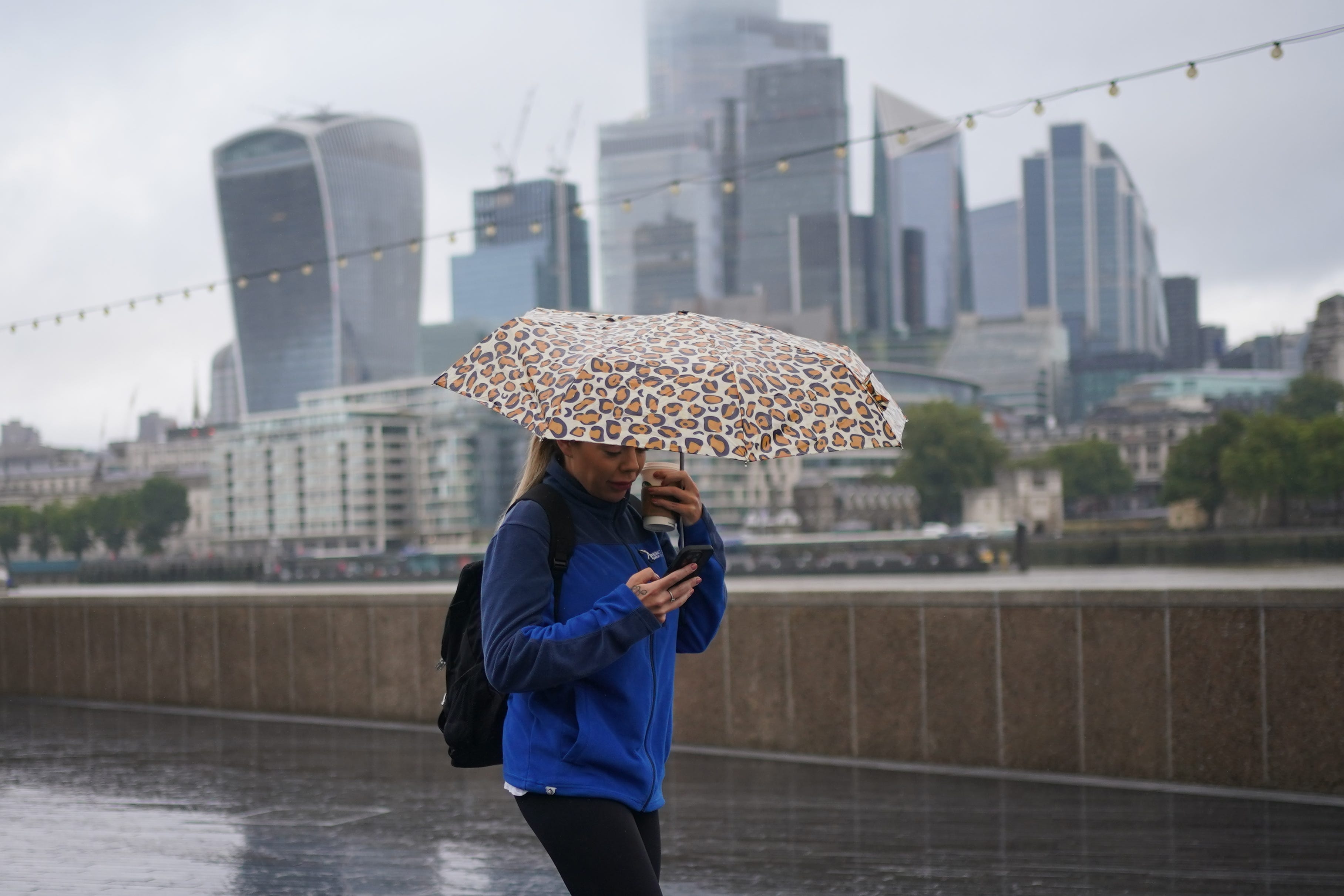 People walking in windy conditions near Tower Bridge in London as Storm Lilian hit the UK on Friday (Yui Mok/PA)