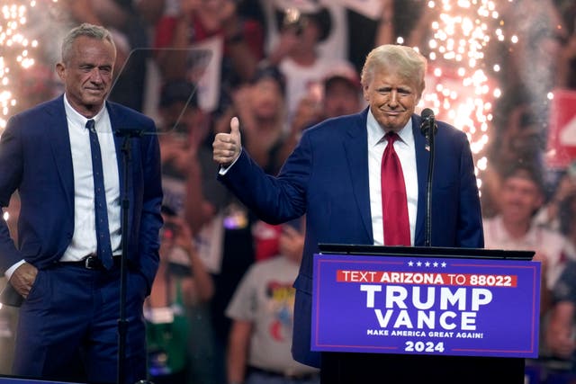 <p>Independent presidential candidate Robert F. Kennedy Jr., left, looks on as Republican presidential nominee former President Donald Trump speaks at a campaign rally Friday, Aug. 23, 2024, in Glendale, Arizona </p>