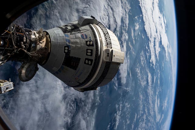 <p>In this photo provided by NASA, Boeing's Starliner spacecraft is docked to the Harmony module of the International Space Station on July 3, 2024, seen from a window on the SpaceX Dragon Endeavour spacecraft docked to an adjacent port</p>