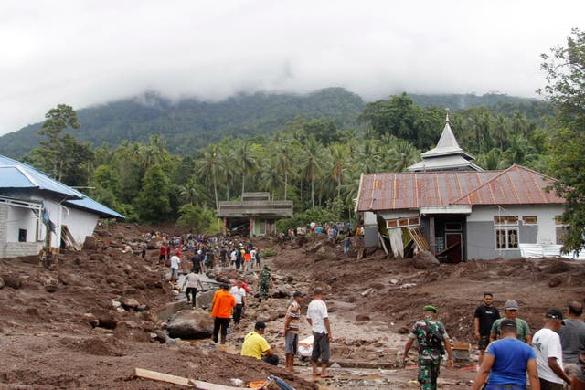 <p>Rescuers and villagers search for the missing </p>