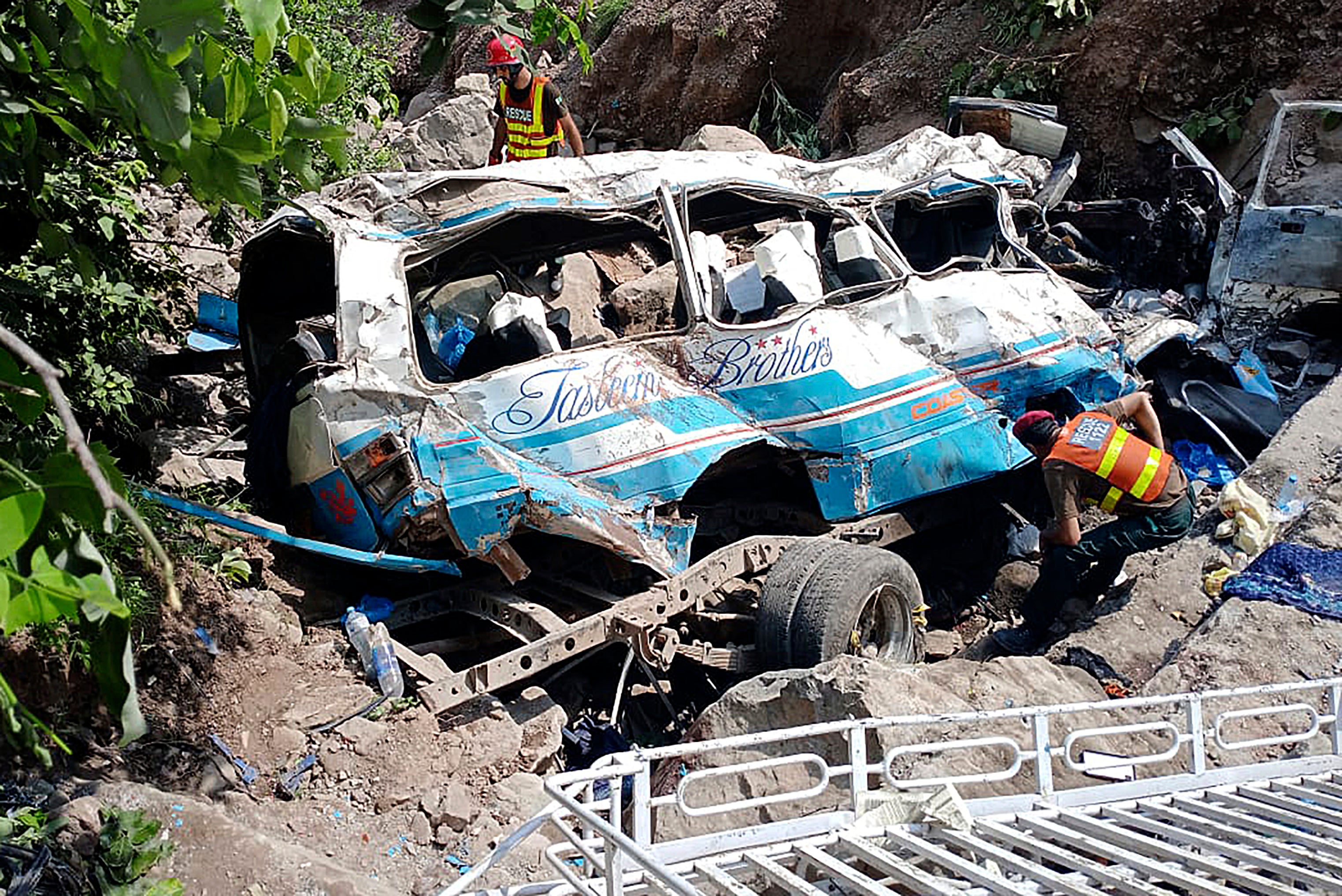 Rescue workers at the scene of a bus crash near Kahuta in Pakistan