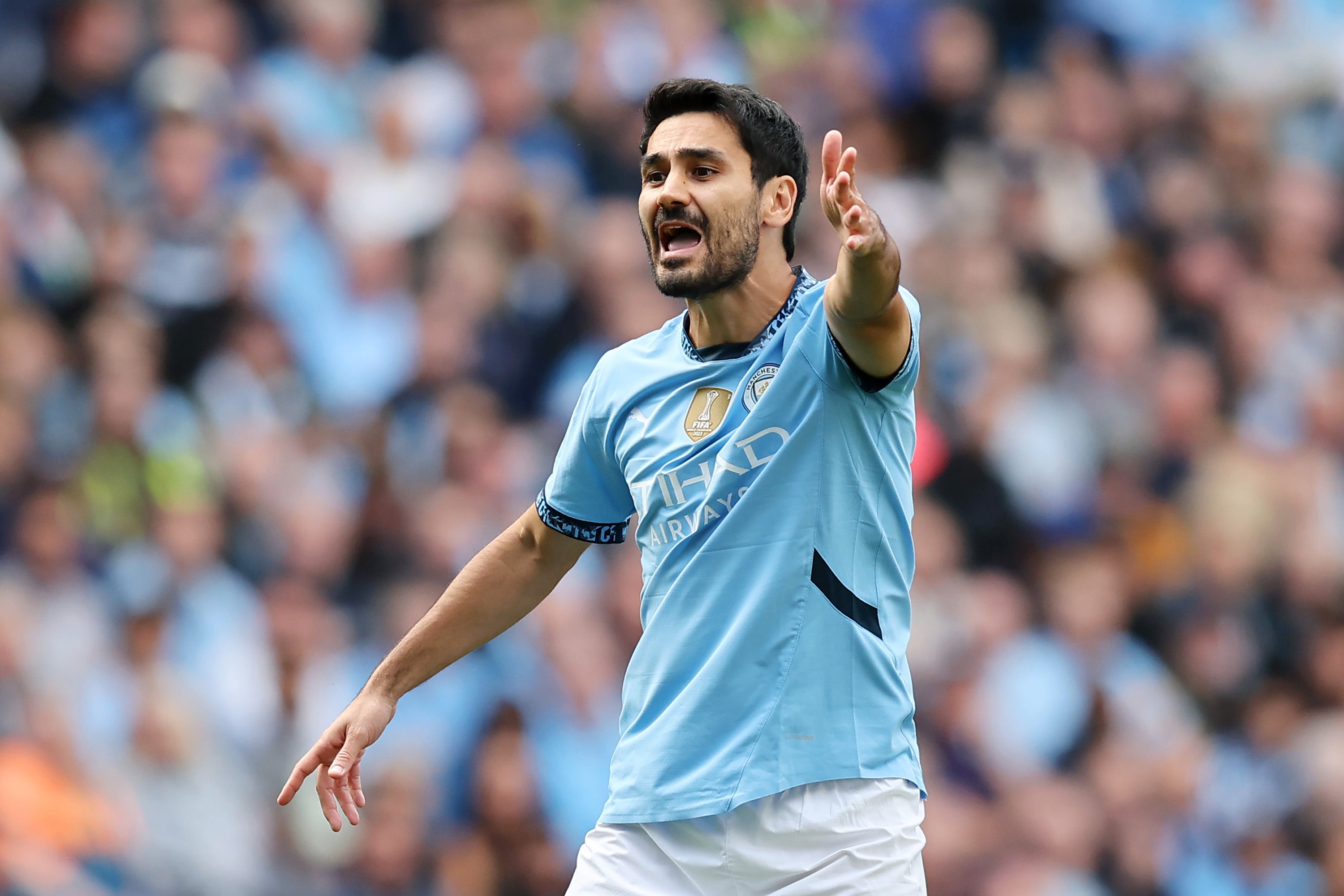 Ilkay Gundogan directs the traffic on his return to the City side