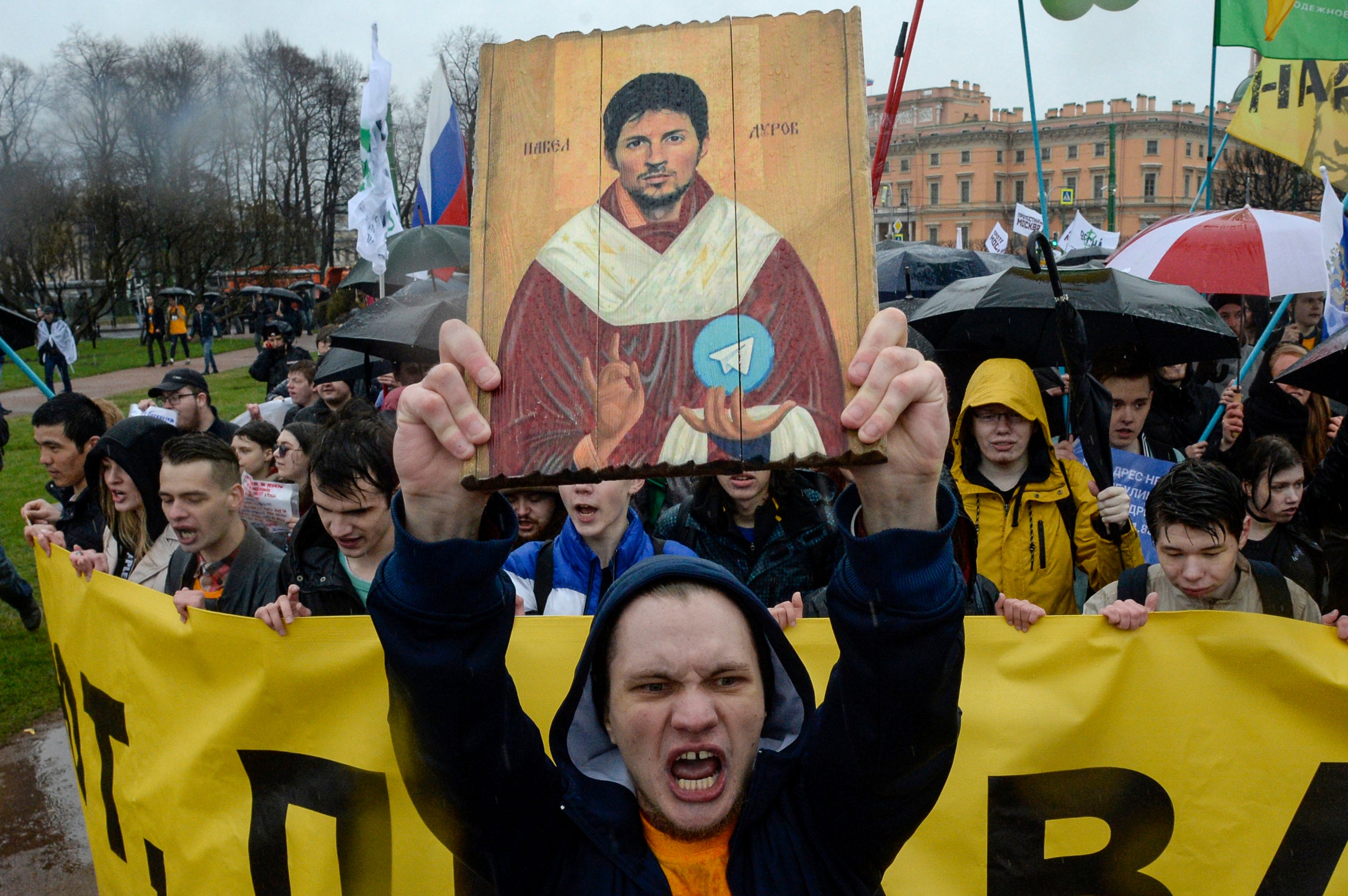 Demonstrators with a icon stylised painting depicting Telegram's founder Pavel Durov protest against the blocking of the popular messaging app in Russia, during a May Day rally in Saint Petersburg on 1 May, 2018