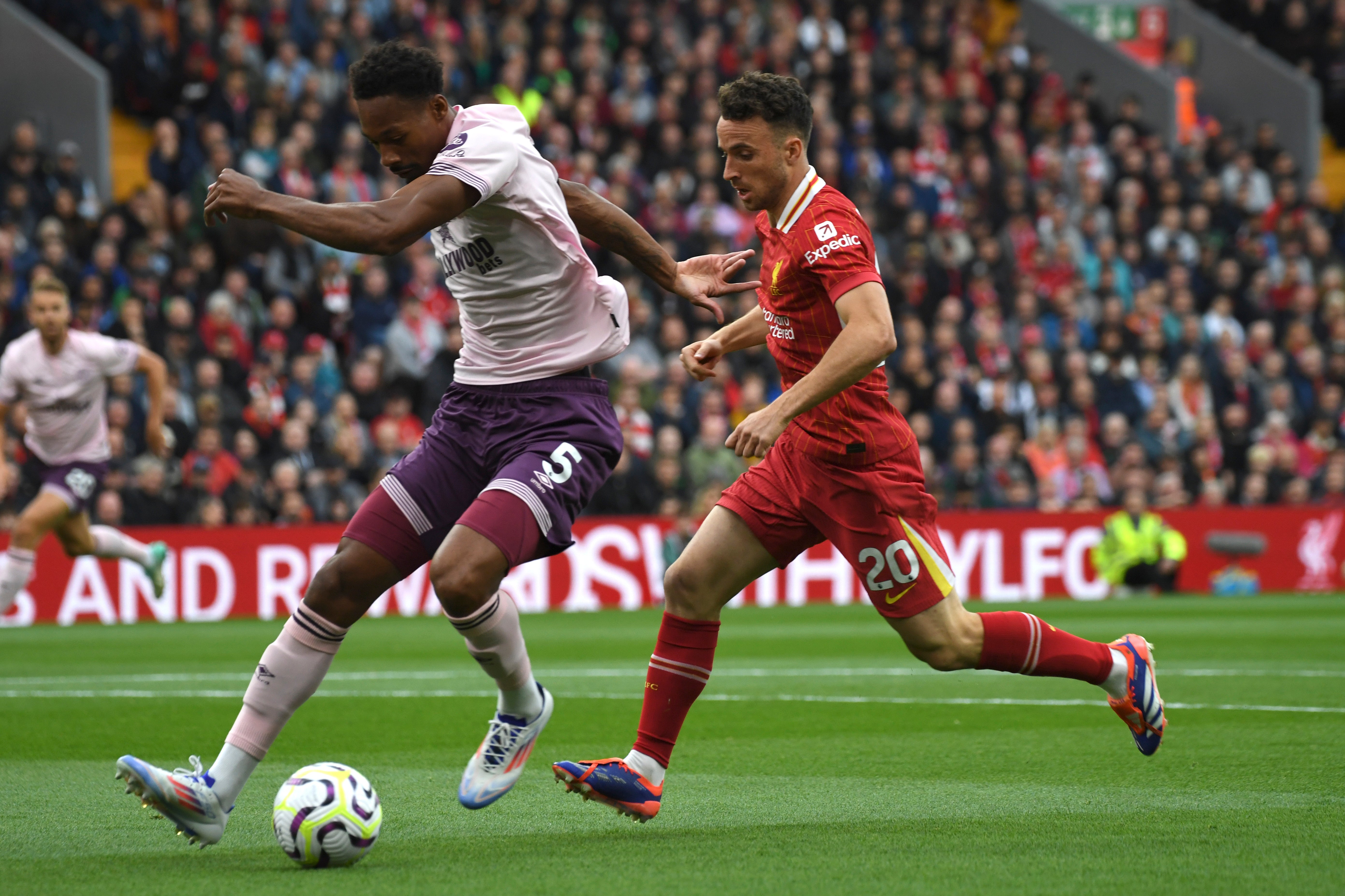 Liverpool's Diogo Jota, right, challenges for the ball with Brentford's Ethan Pinnock