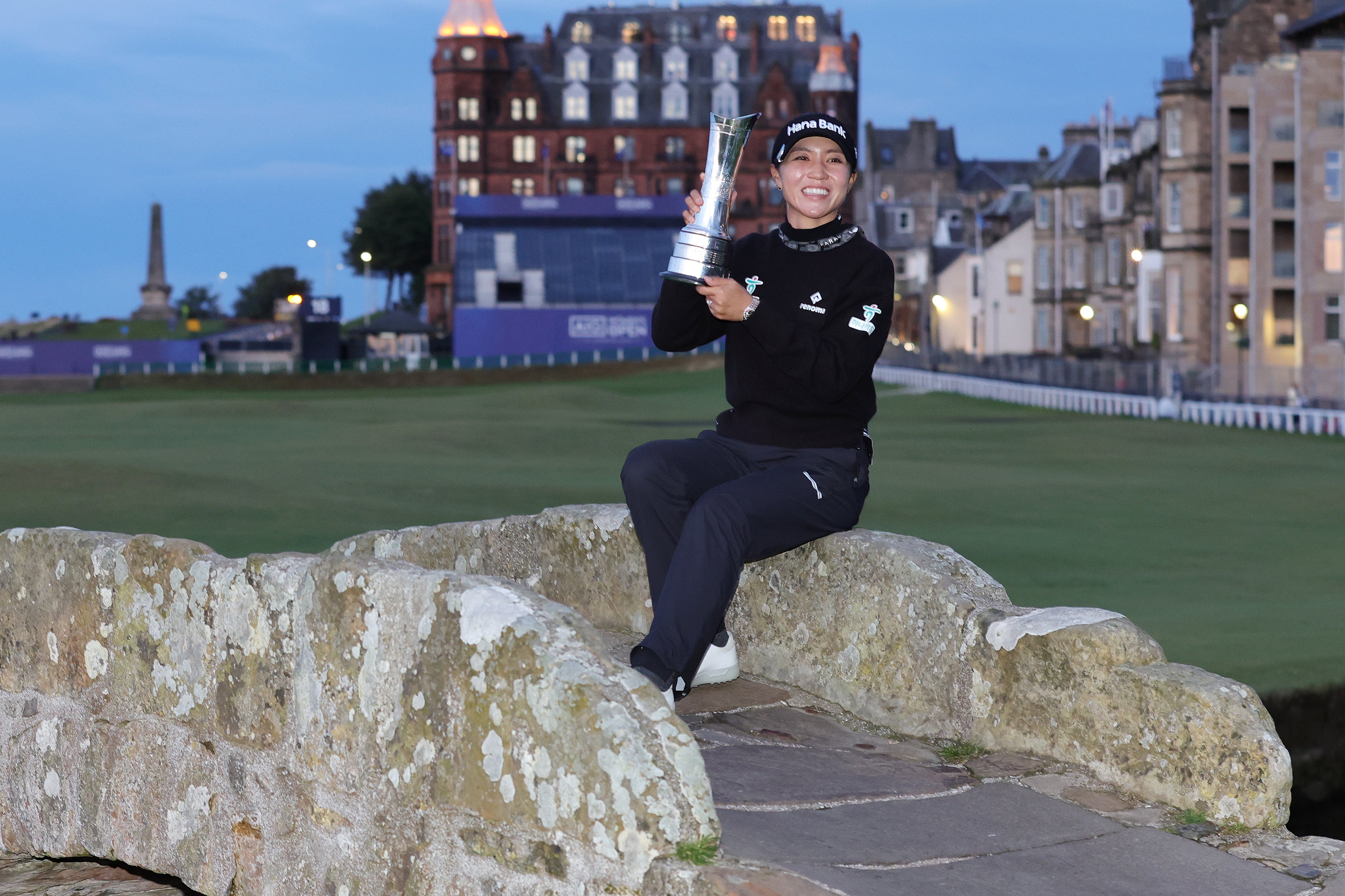 Lydia Ko poses on the Swilcan Bridge after her victory at the Open