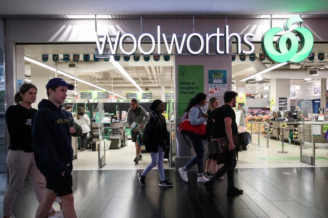 <p>File: People walk past a Woolworths supermarket in Sydney</p>