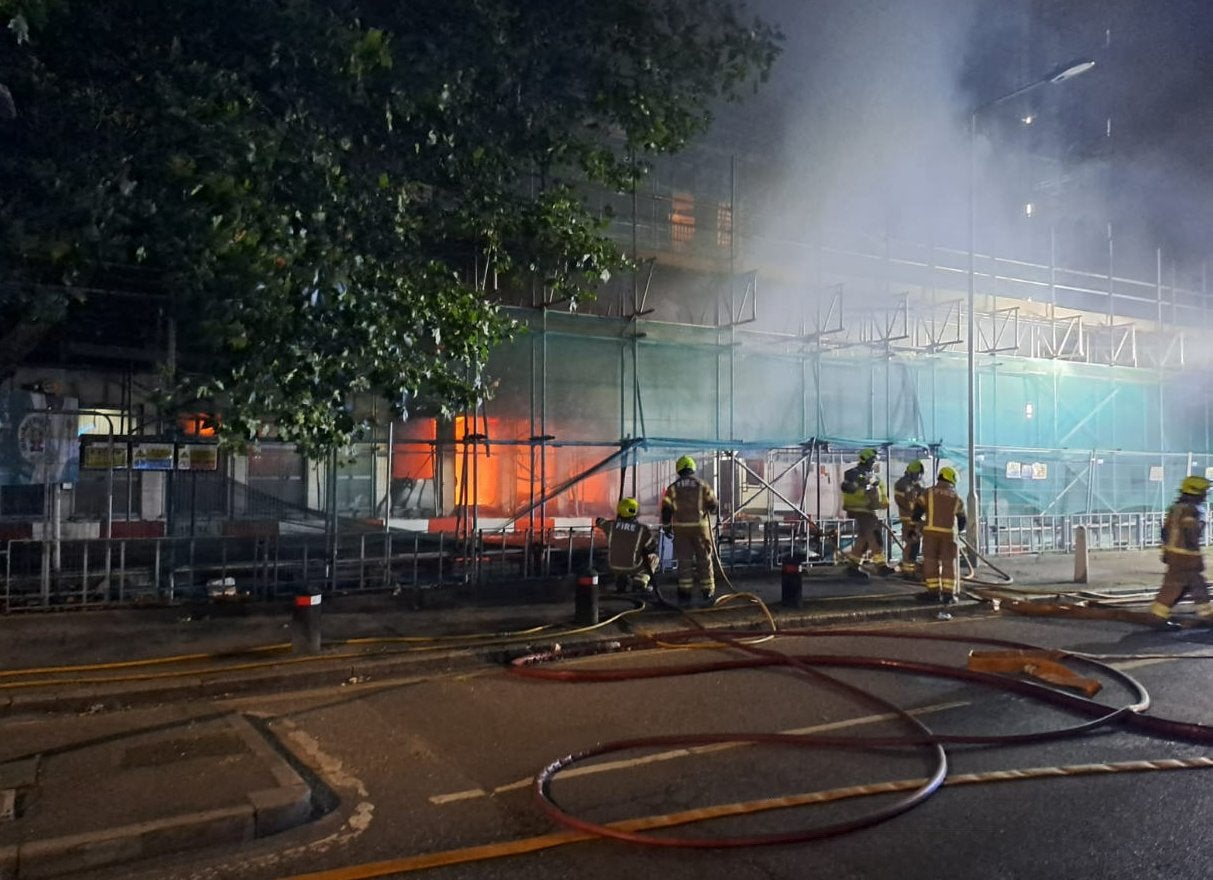 Firefighters tackle a ground floor blaze of the tower block in Dagenham, east London