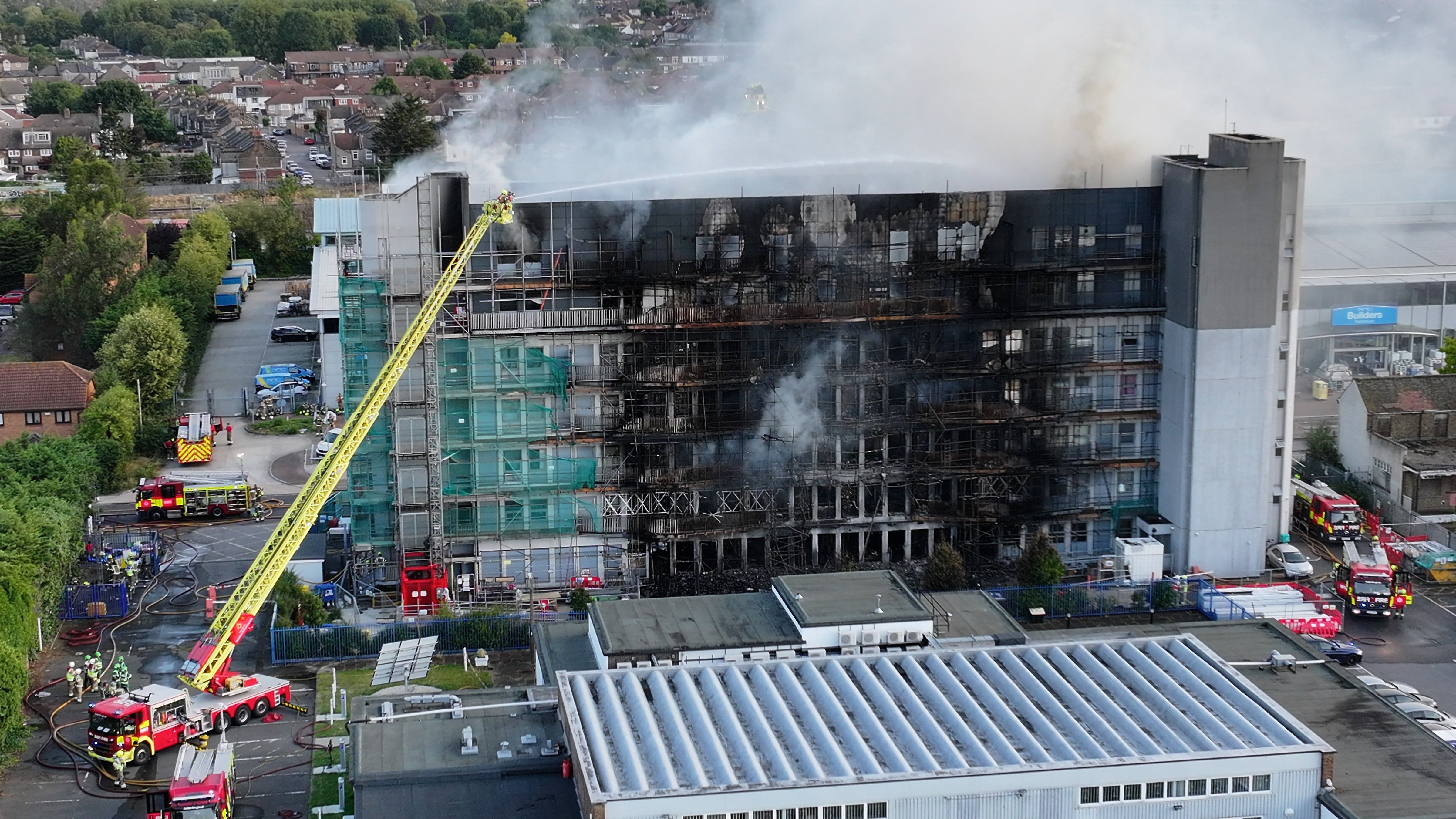 The smoldering ruins of the Dagenham tower block were visible in daylight this morning