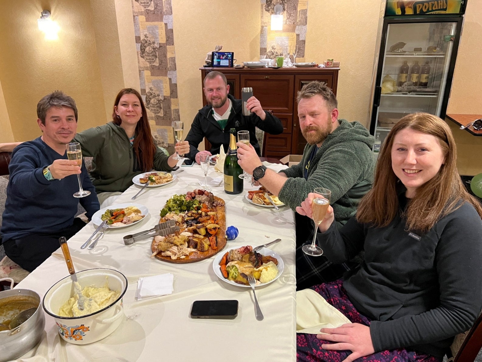 Reuters cameraman Herbert Villarraga, Reuters producer Asya Shtefan, Reuters safety advisor Steve Kelly, Reuters safety advisor Ryan Evans and Reuters photographer Clodagh Kilcoyne have dinner cooked by Ryan Evans on Christmas Day at the Sapphire hotel, in Kramatrosk Ukraine, 25 December 2022