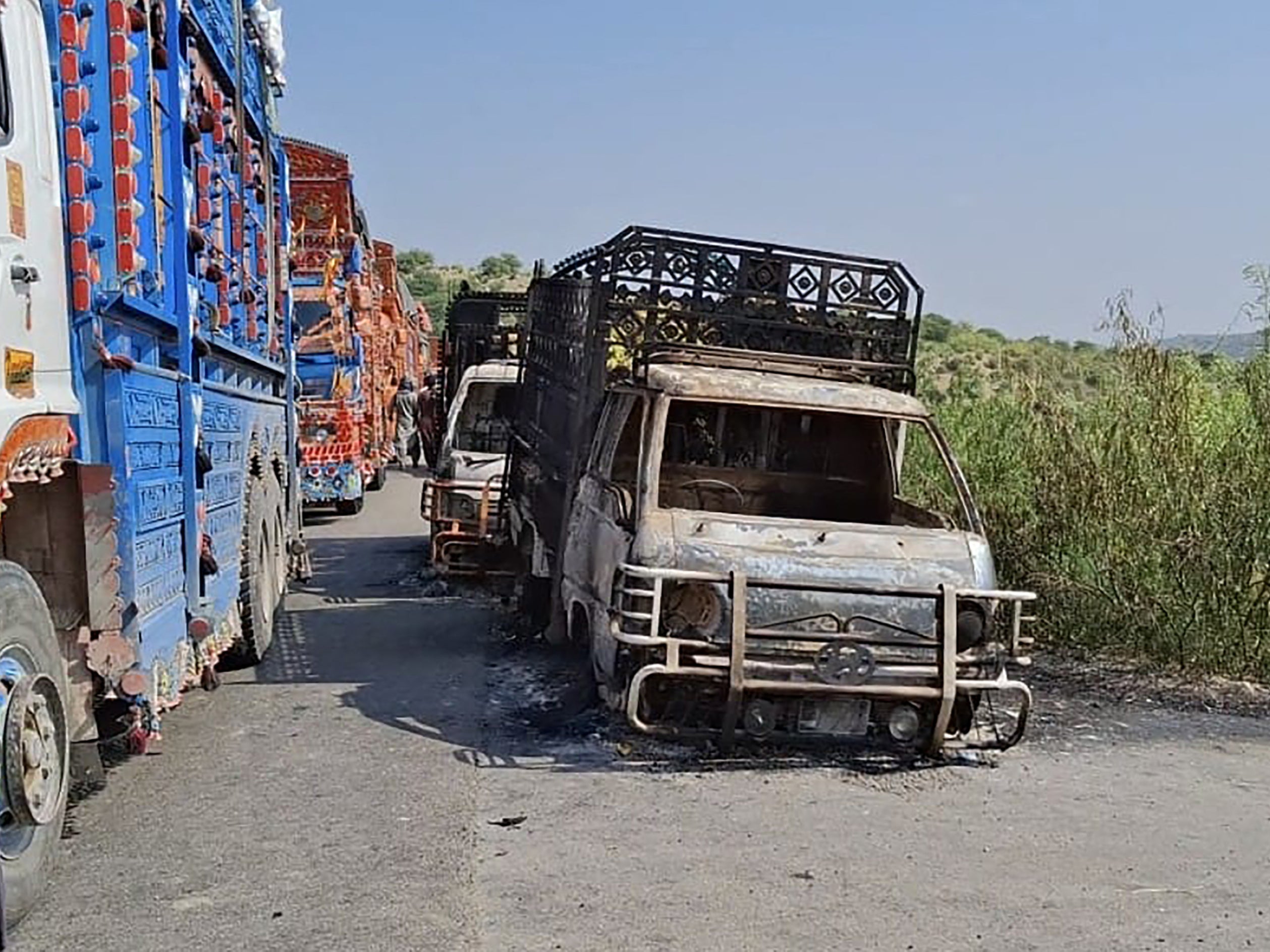 Charred vehicles at the site of the shooting on the national highway in Musakhail district, Balochistan