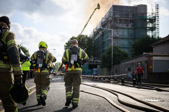 <p>Fire teams attempt to extinguish a major fire in an apartment block in Dagenham</p>