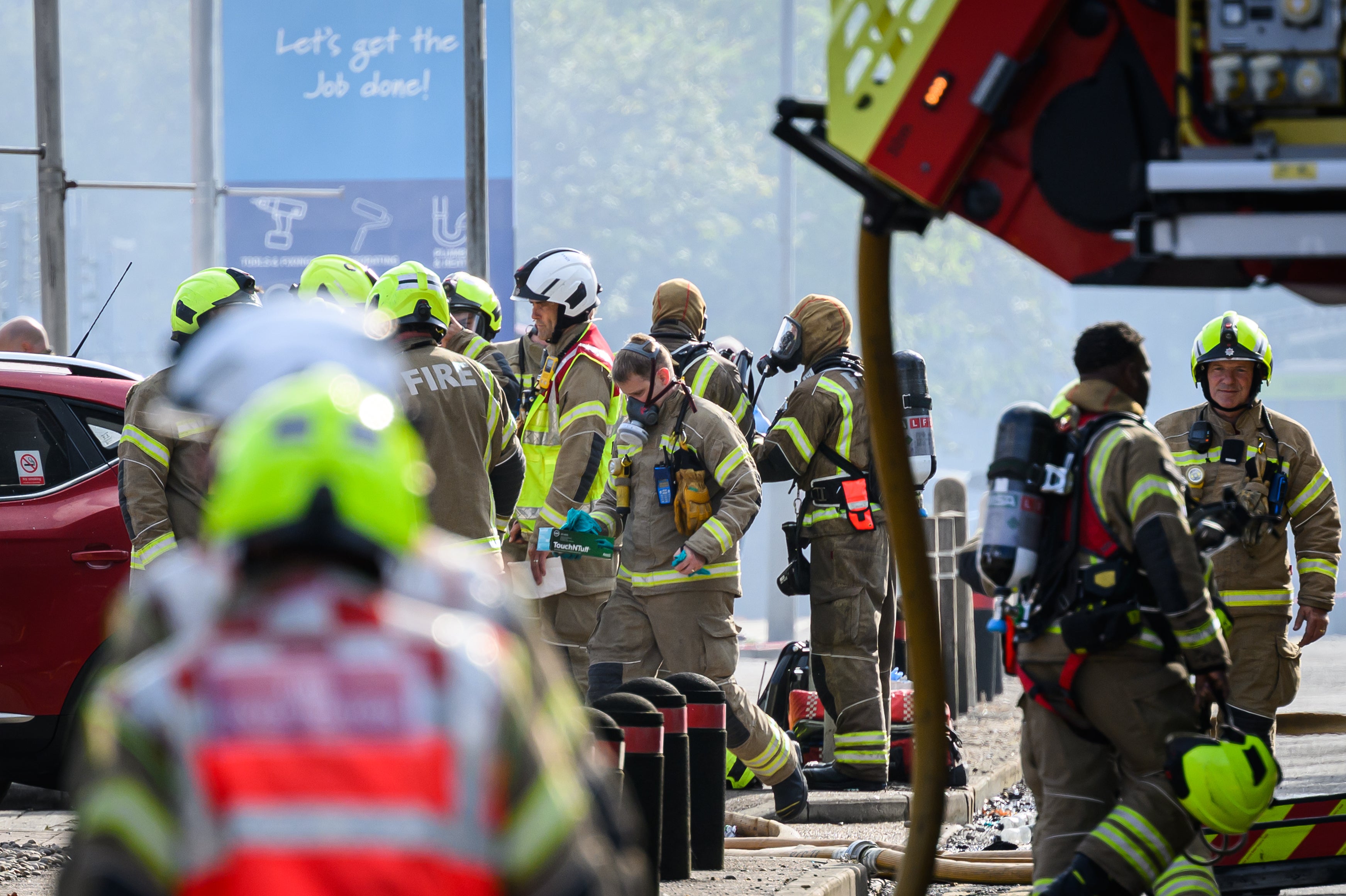 Dozens of firefighters outside east London tower block after it was engulfed by flames on Monday morning