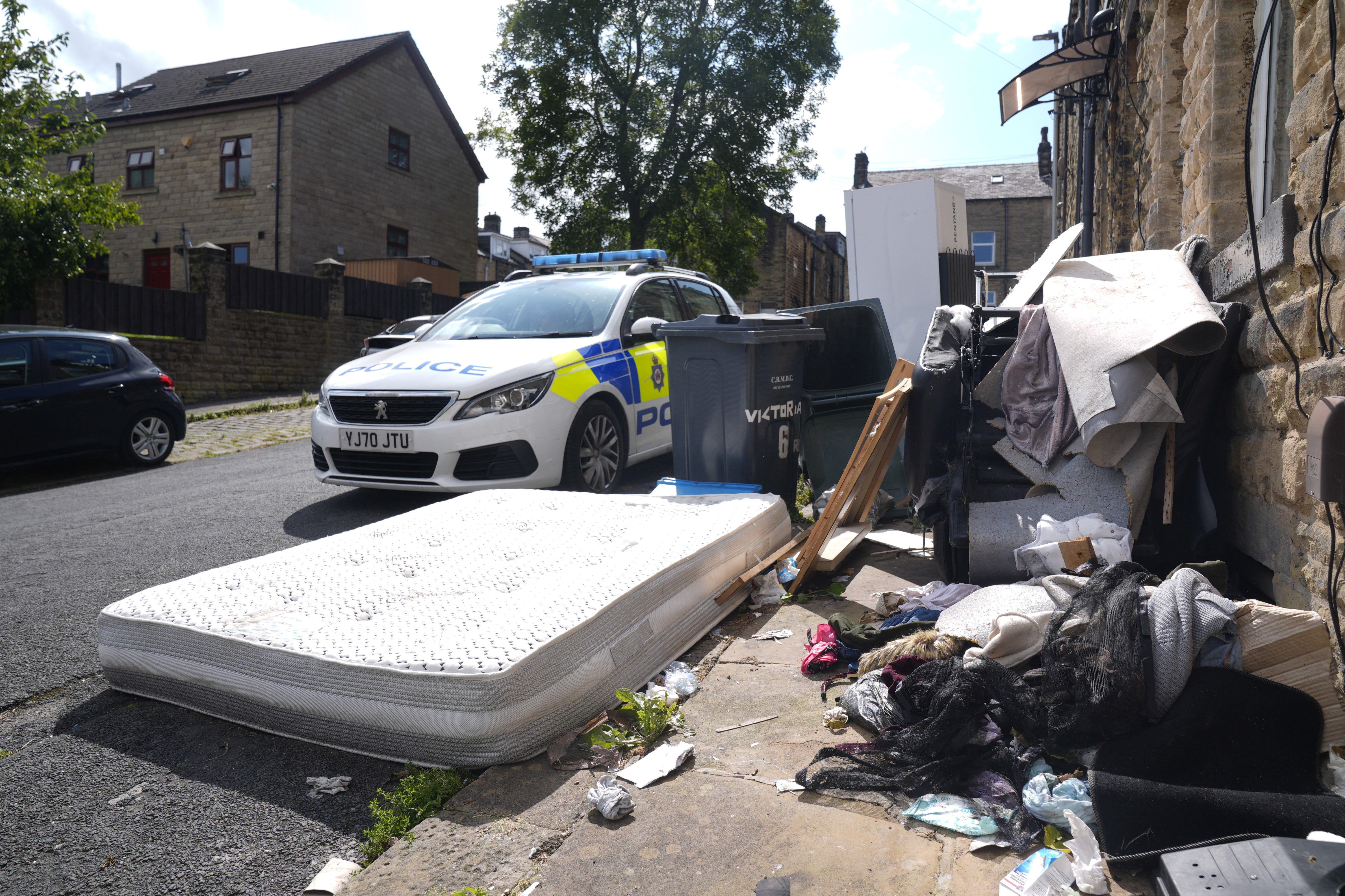 Police pictured outside a house in Minnie Street following the fatal fire